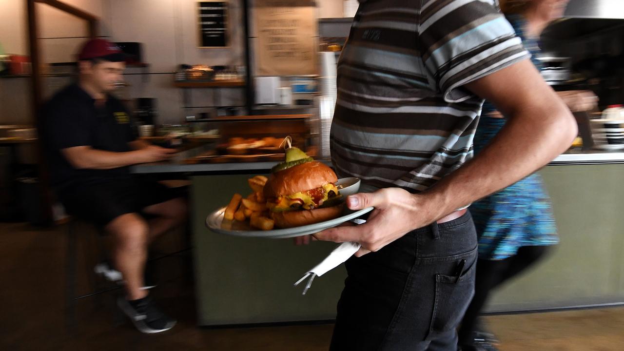An employee serving food at a cafe (file image)