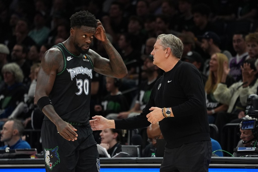 minnesota timberwolves player julius randle scratching his head while talking to coach chris finch