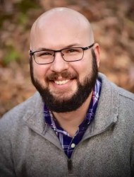 A man in a grey sweater.