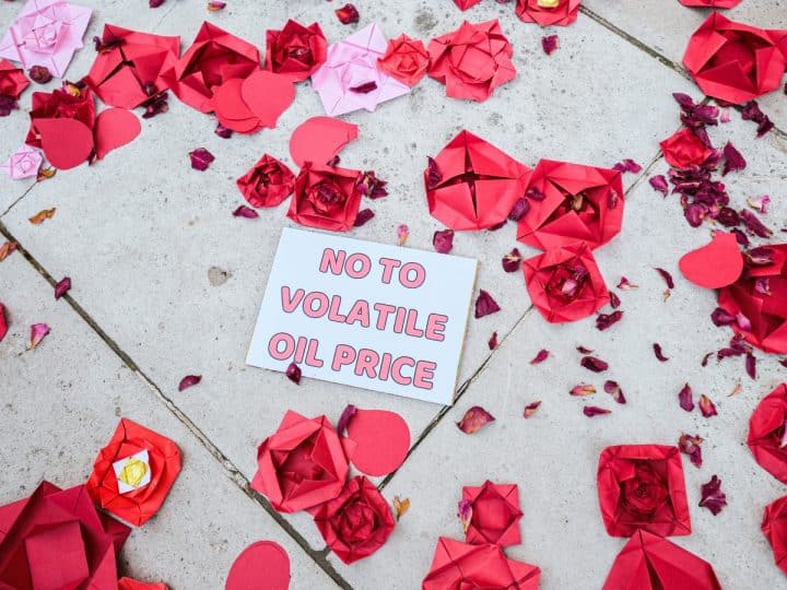 Christian Climate Action against Rosebank with paper roses and a message saying No To Volatile Oil Price