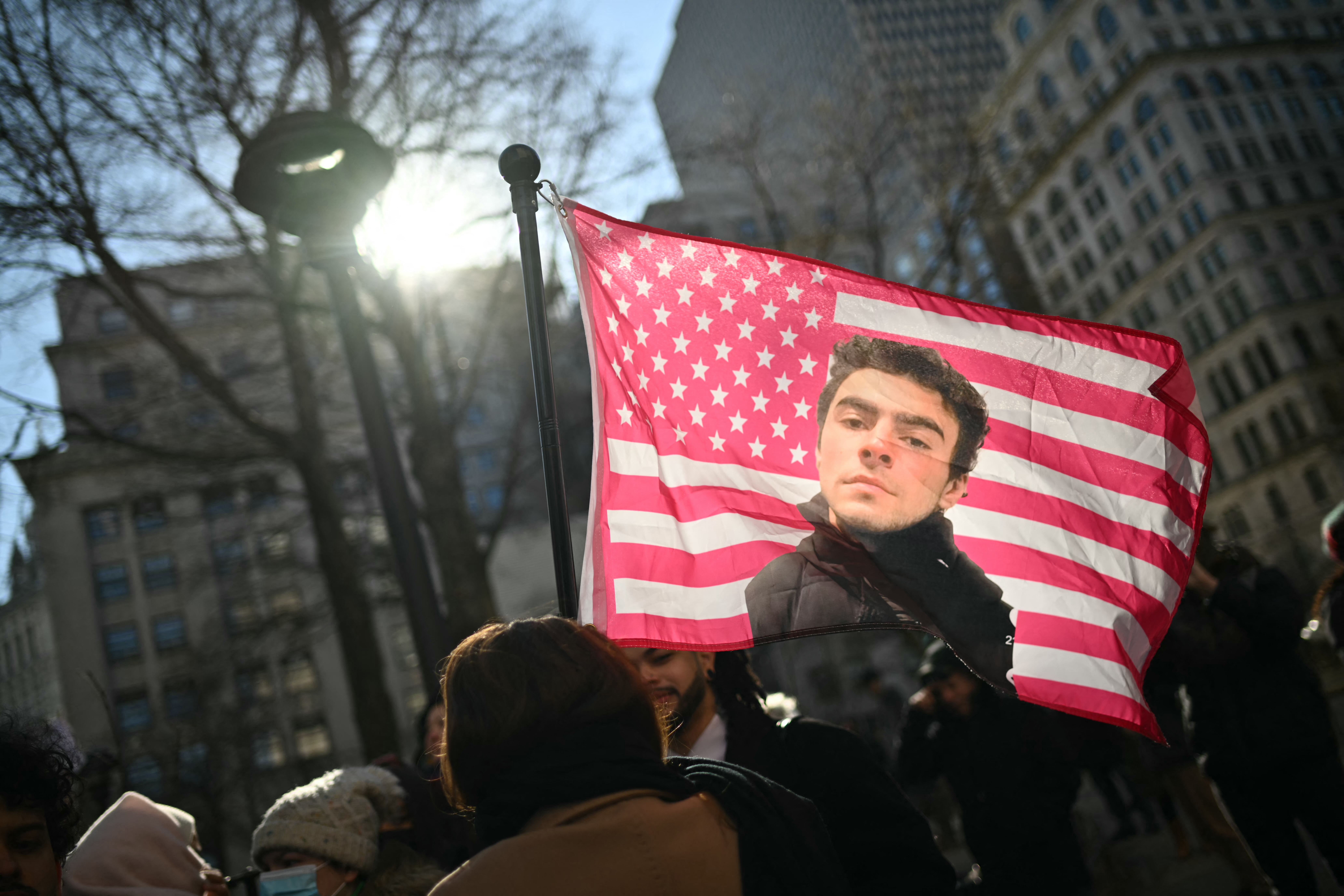 Protesters hold signs outside the Criminal Court where Luigi Mangione, accused killer of US insurance CEO Brian Thompson, attends a hearing in New York City on February 21, 2025.