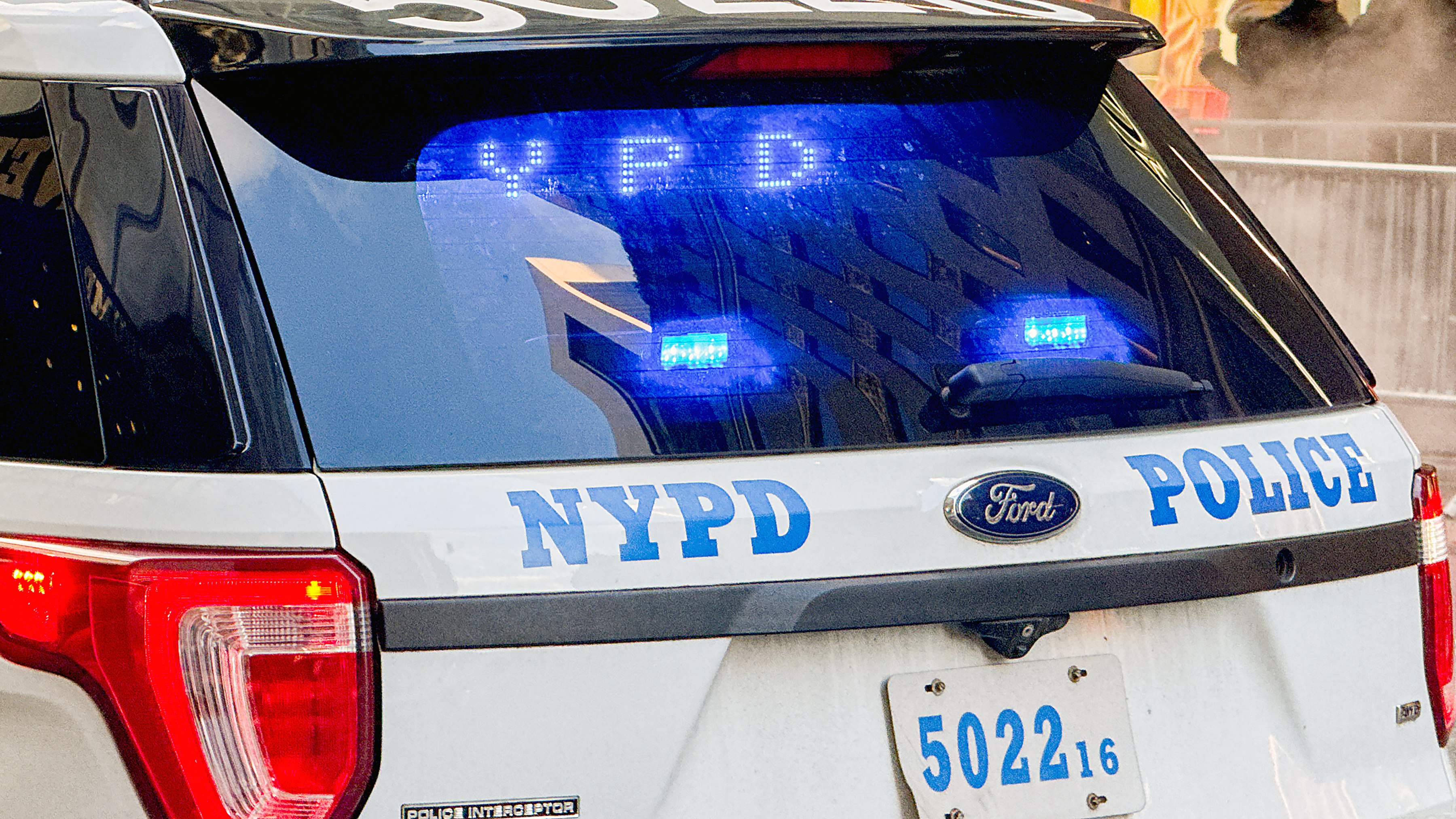 Close up view of a police patrol car of the New York Police Department NYPD with flashing blue lights.