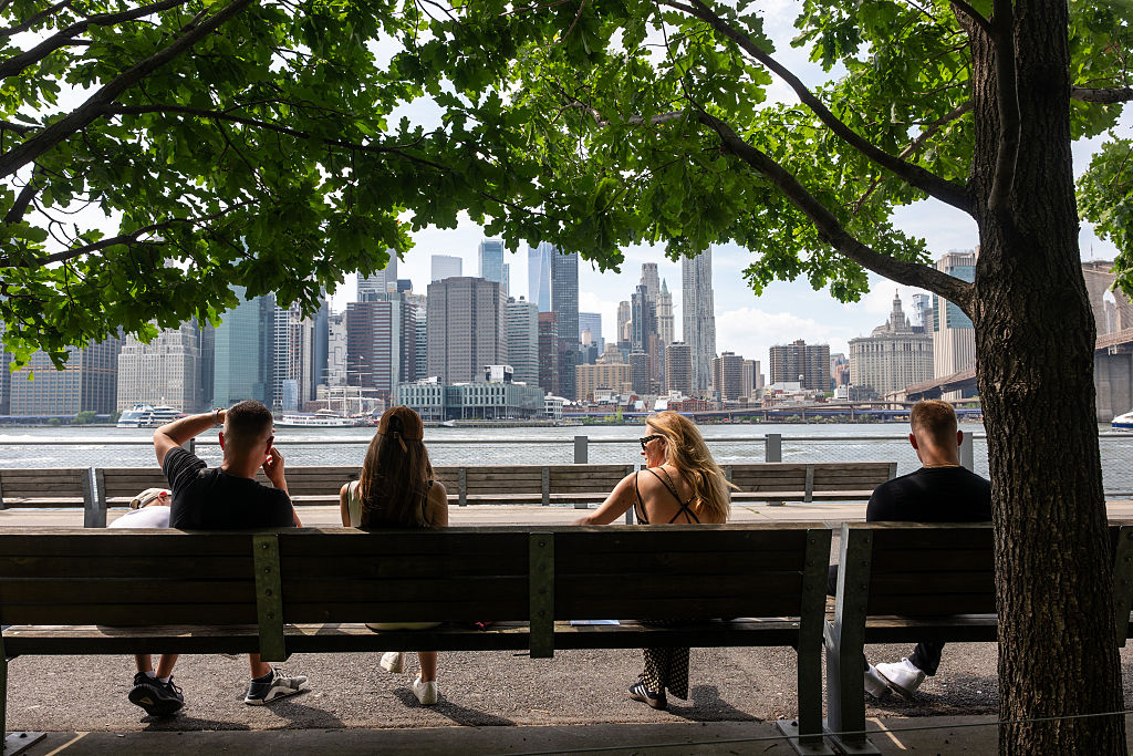 People try to keep cool by the water in the Dumbo section of Brooklyn on June 12, 2026, when temperatures reached into the 90s.