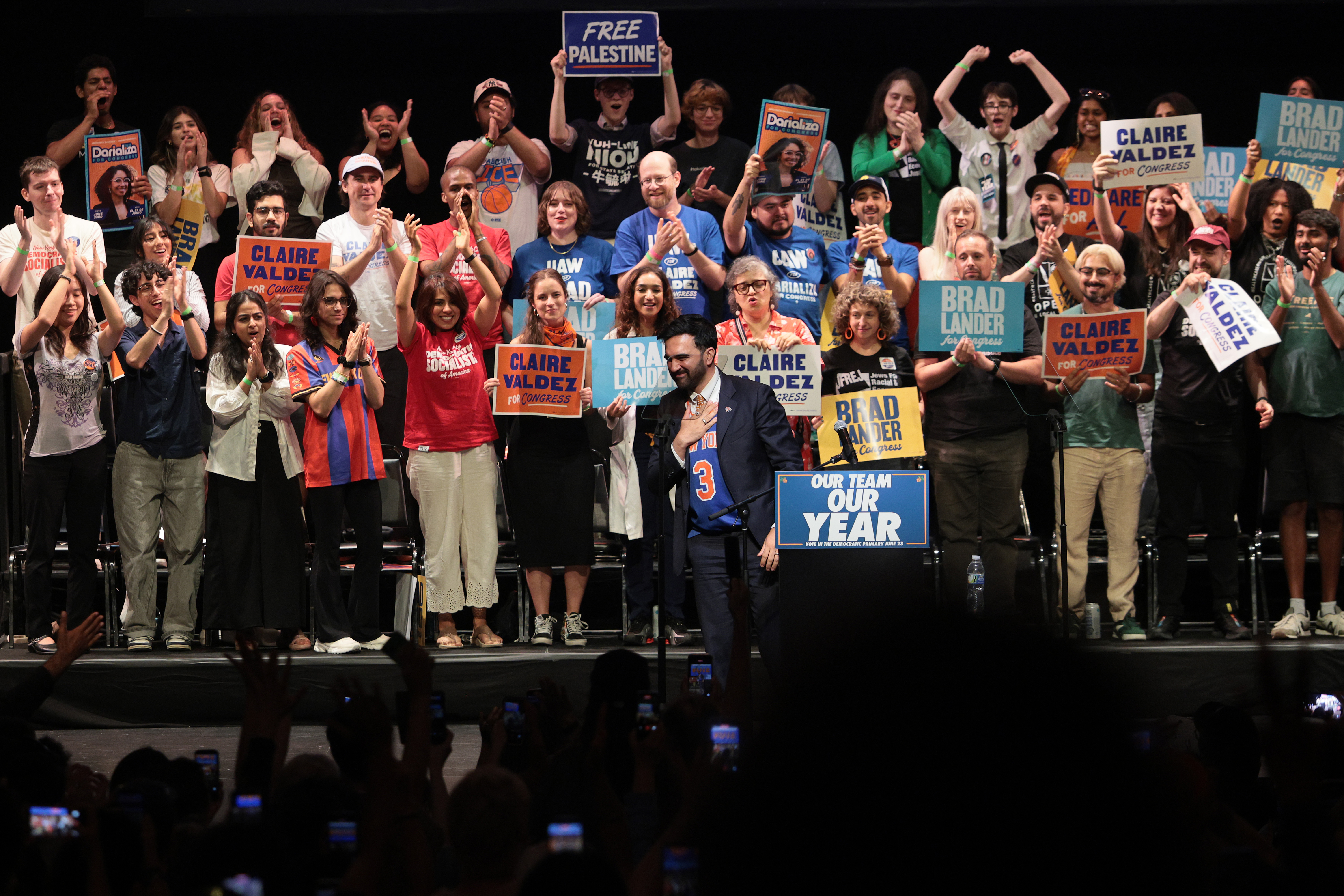 Mamdani on stage with supporters.