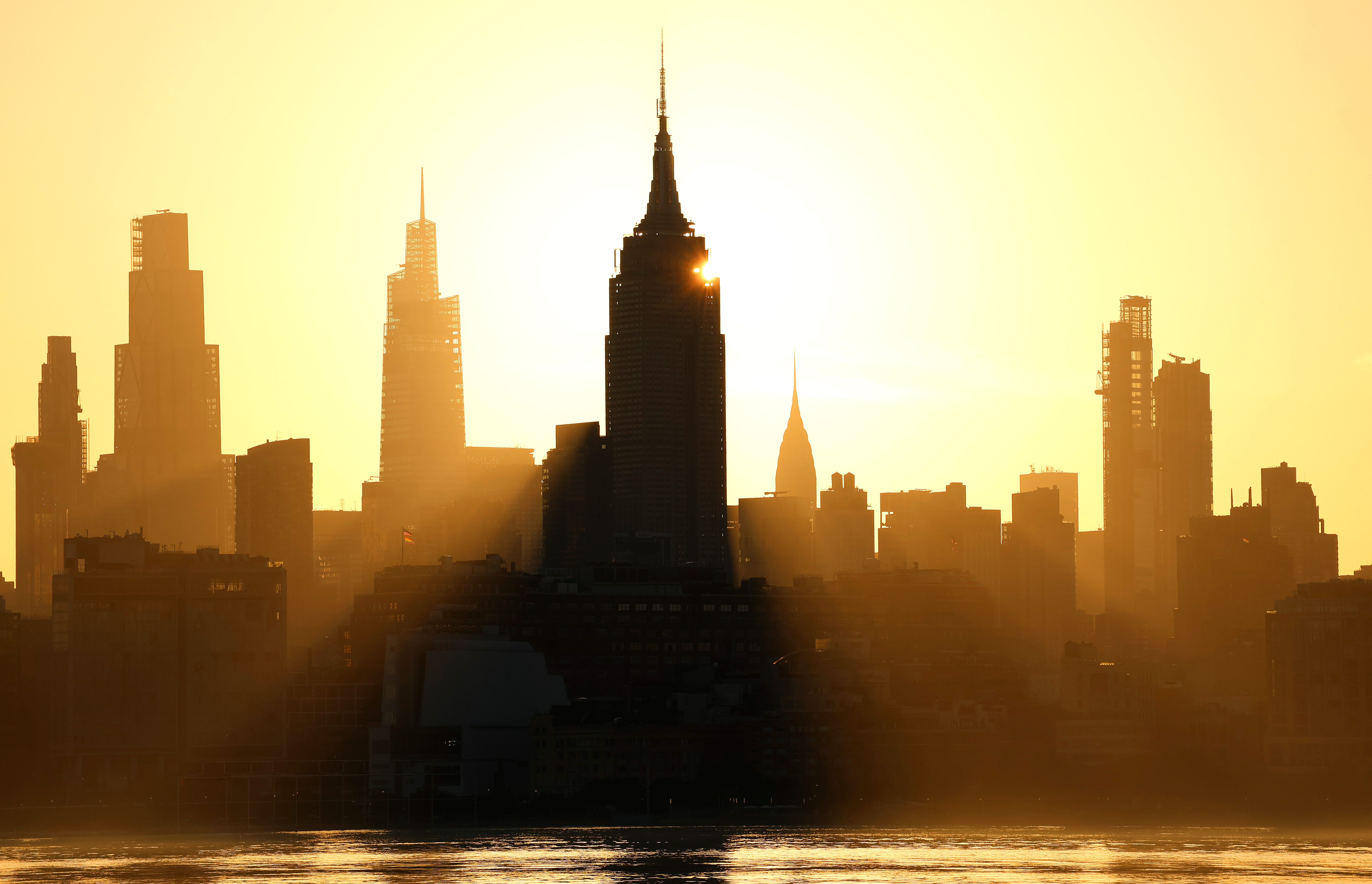 An image of the sun rising behind the Manhattan skyline during a deadly heat wave last year.