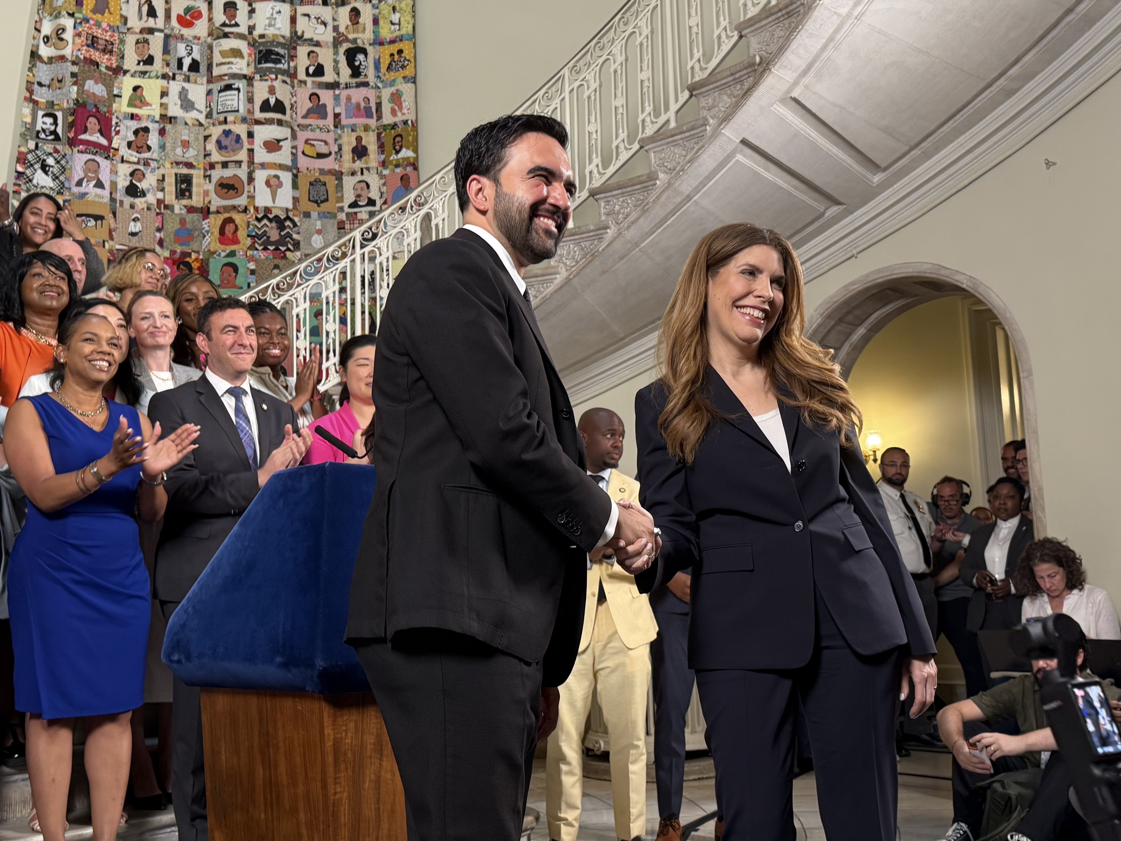 Mayor Zohran Mamdani and City Council Speaker Julie Menin shake hands.