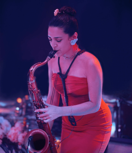 Woman in a red dress playing a saxophone. 