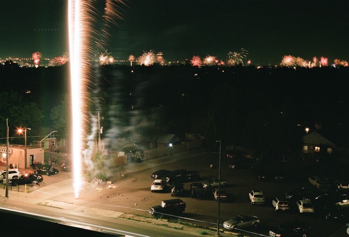 A firework going off in a dark parking lot