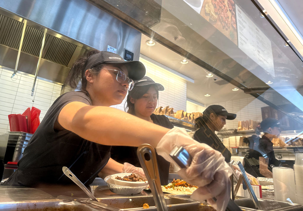 Workers fill food orders at a Chipotle restaurant. Minimum hourly wages for Oregon workers will rise by 50 cents per hour on July 1, 2026 to keep up with inflation. (Photo by Justin Sullivan/Getty Images)
