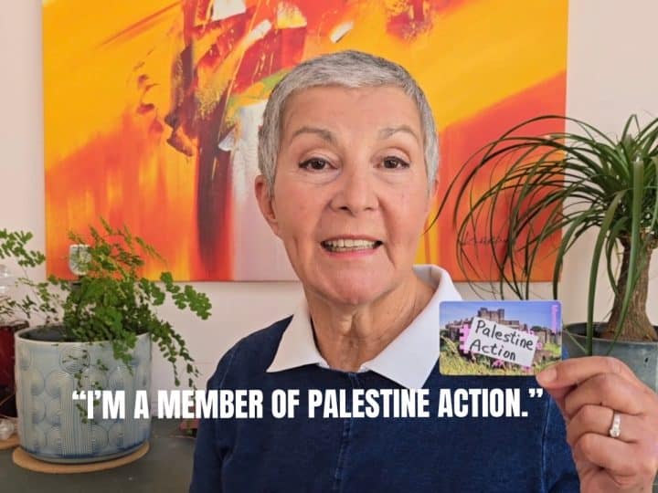 A person holds a pretend Palestine Action membership card