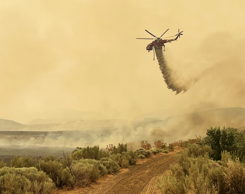A helicopter drops flame retardant on the Cow Valley Fire in eastern Oregon on July 12, 2024. Scientists expect wildfires to continue to intensify with climate change. (Photo by Matt Fisher of Umatilla Task Force/Northwest Interagency Coordination Center)