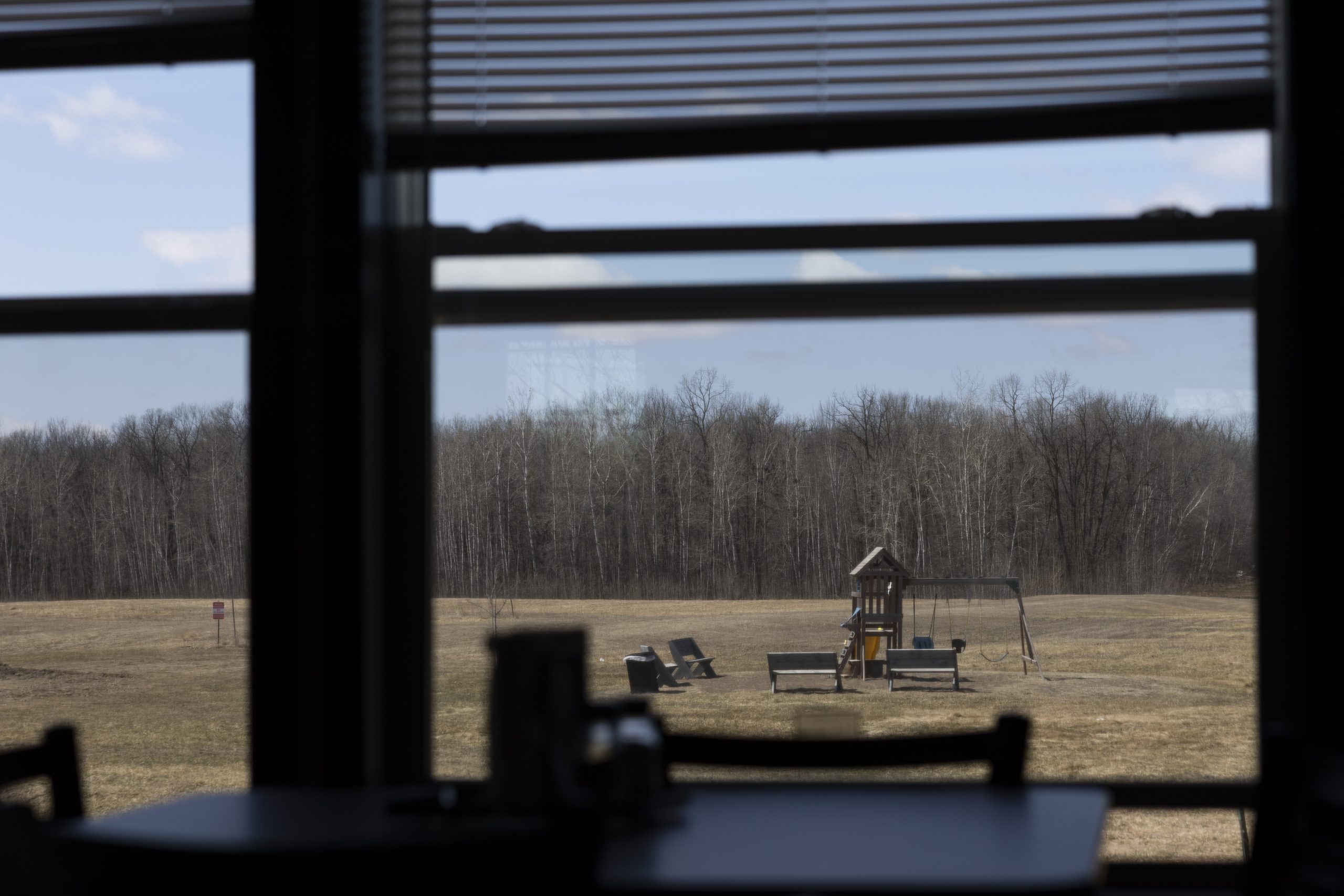a playground is seen from the window of the dining room in the apartments