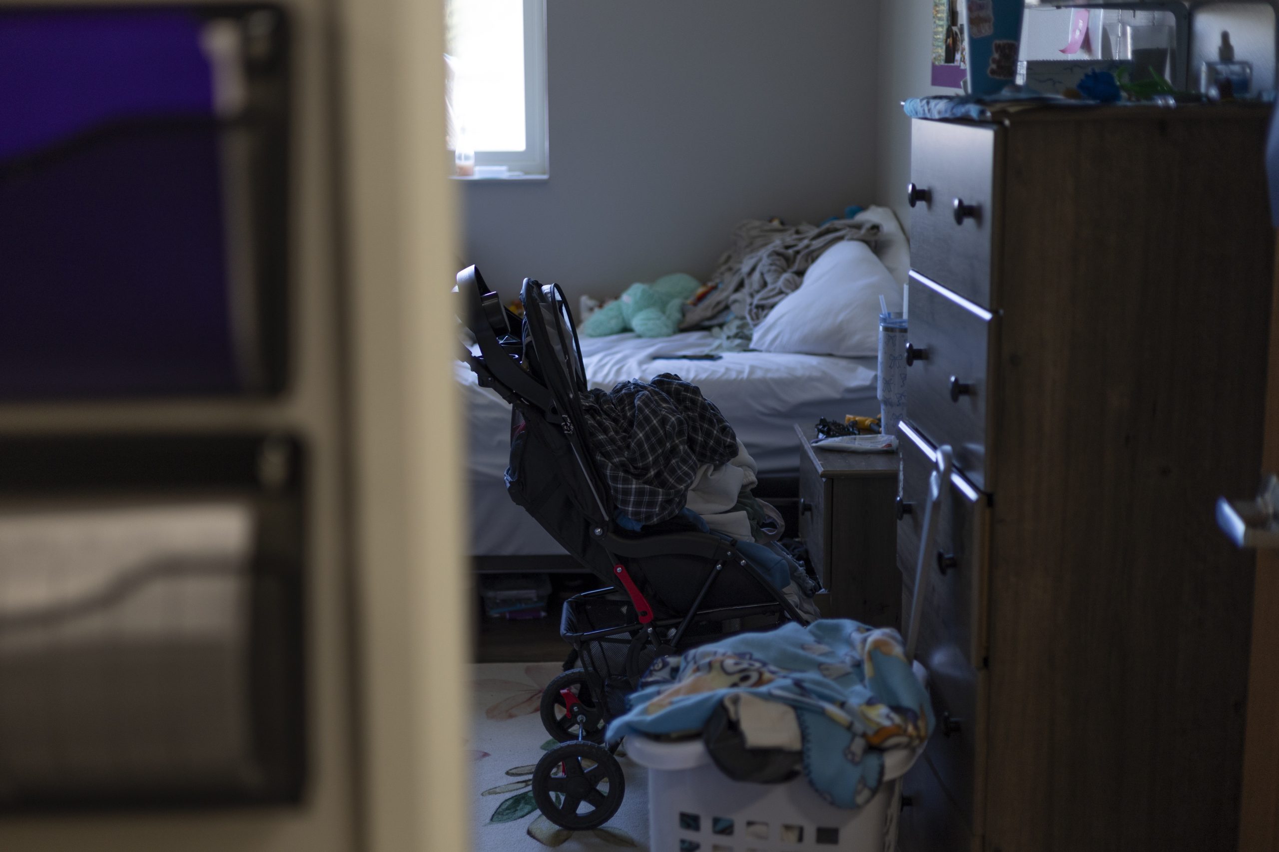 a view of a client's room through the doorway including a stroller and supplies for a young child