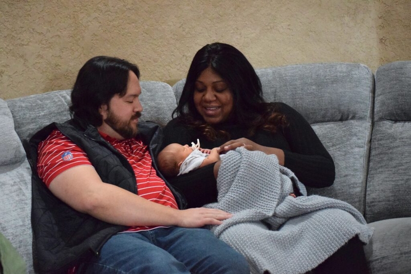 A couple sits with their newborn inside their Bentonville, Arkansas, home. The Trump administration is shifting the federal Title X program, which has traditionally provided access to contraception, toward an emphasis on childbearing. (Photo by Antoinette Grajeda/Arkansas Advocate)