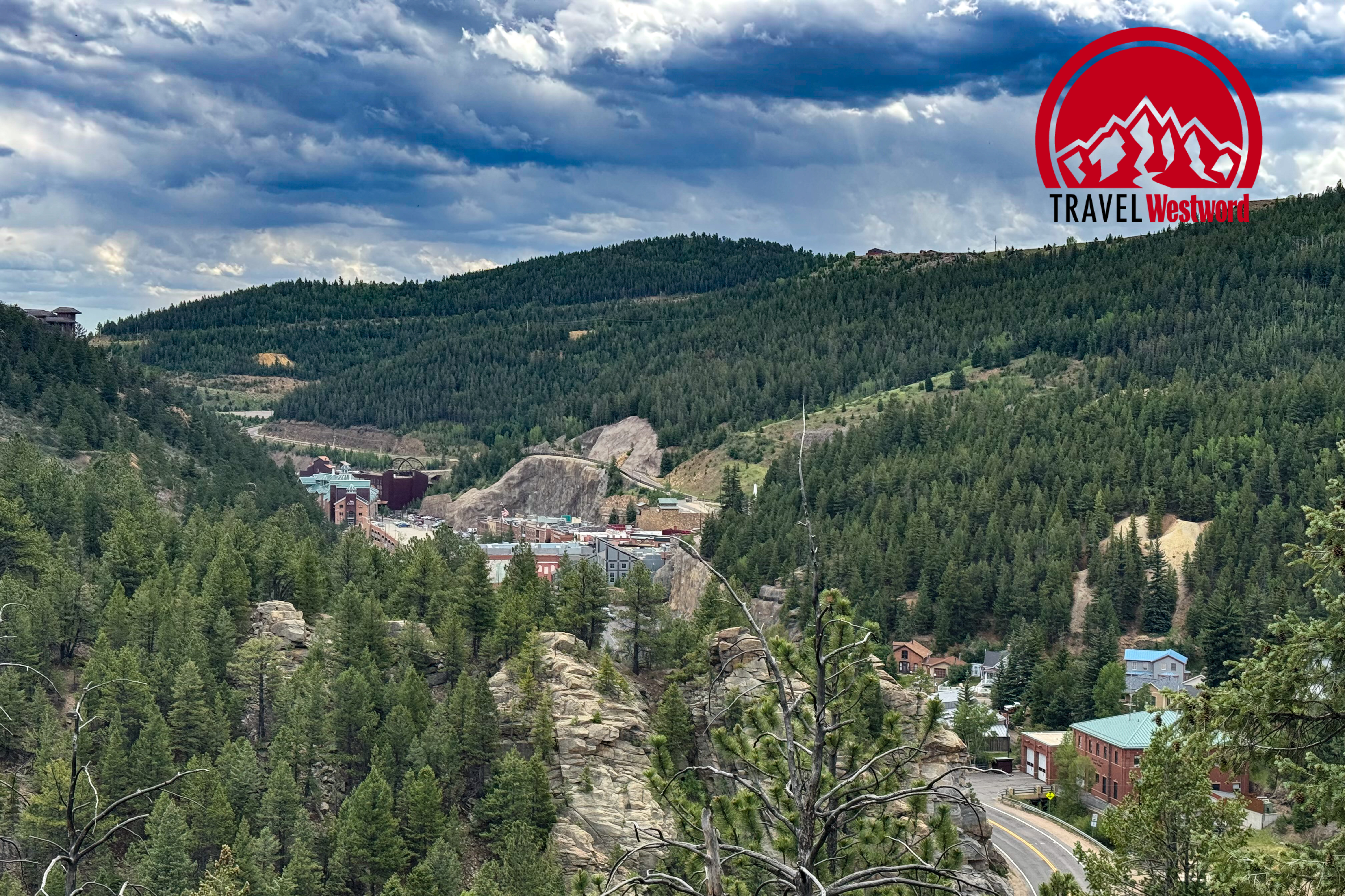 An aerial view of Black Hawk. The city and casinos sit nestled in between trees and mountains.