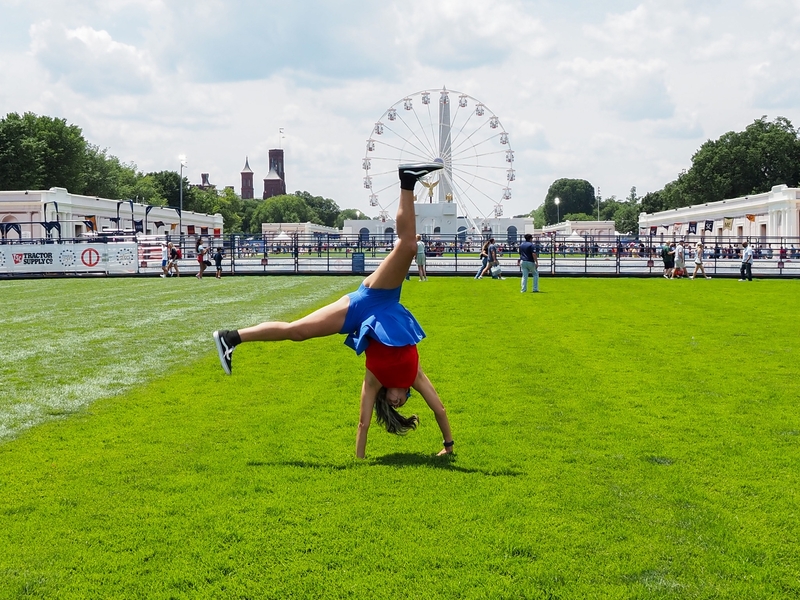 Tanya Geders, 43, of St. Louis, Missouri, modeled a cartwheel for her son on the National Mall at the Freedom 250 Great American State Fair on Thursday, June 25, 2026. (Photo by Ashley Murray/States Newsroom)