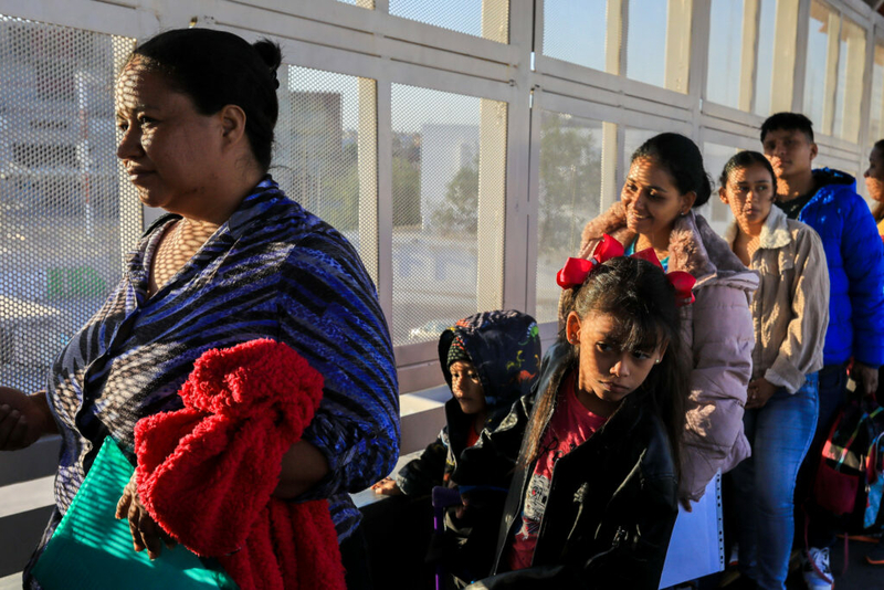A family waits in line to apply for asylum at the southern border between El Paso, Texas, and Ciudad Juárez, Mexico, in 2023. (Photo by Corrie Boudreaux for Source NM)