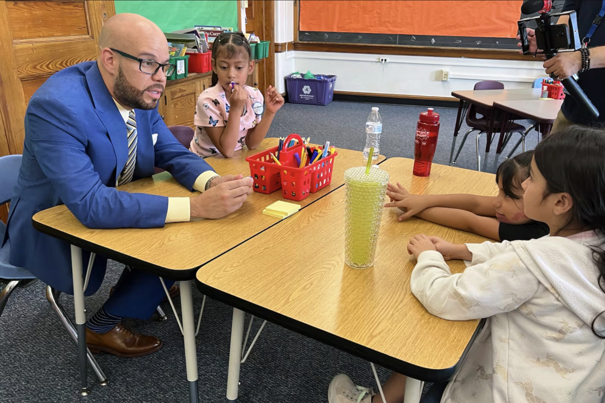 Denver Public Schools Superintendent Alex Marrero talks with students on the first day of school in 2024.