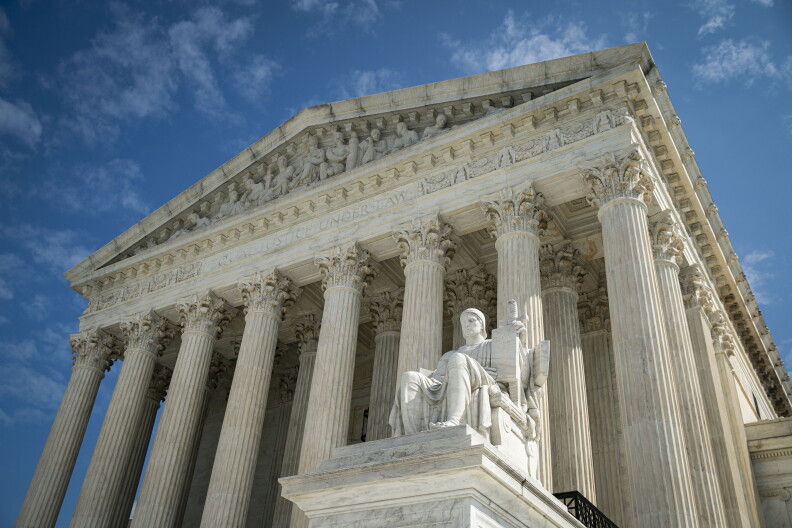 The front facade of the Supreme Court has multiple columns.