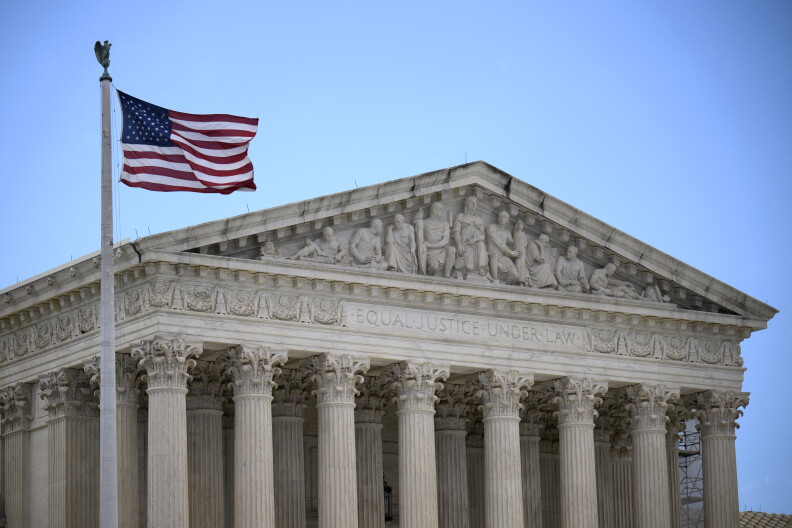 Thr front facade of the Supreme Court with chairs and columns.