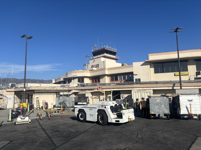A tower marked BUR is visible in a photo taken from an airport tarmac.