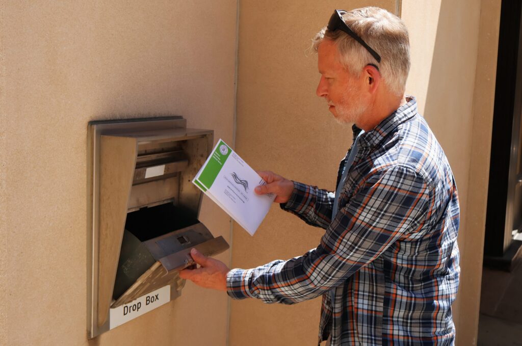 Greg Lange of Bismarck, North Dakota, drops off his absentee ballot and his wife's at the Bismarck Burleigh County Office Building on June 8, 2026. (Photo by Michael Achterling/North Dakota Monitor)