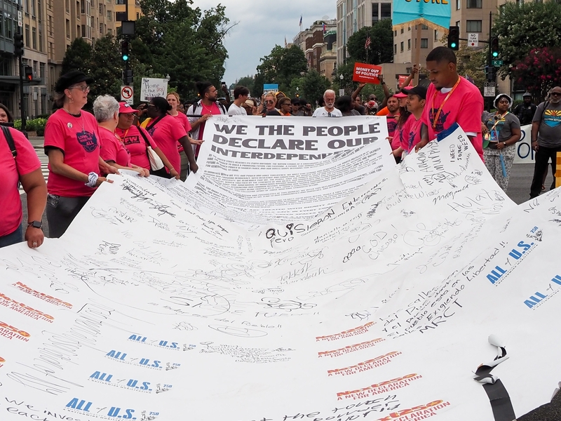 Marchers carried a "Declaration of Interdependence" during a Next250 demonstration in Washington, D.C., on Saturday, June 27, 2026. (Photo by Ashley Murray/States Newsroom)