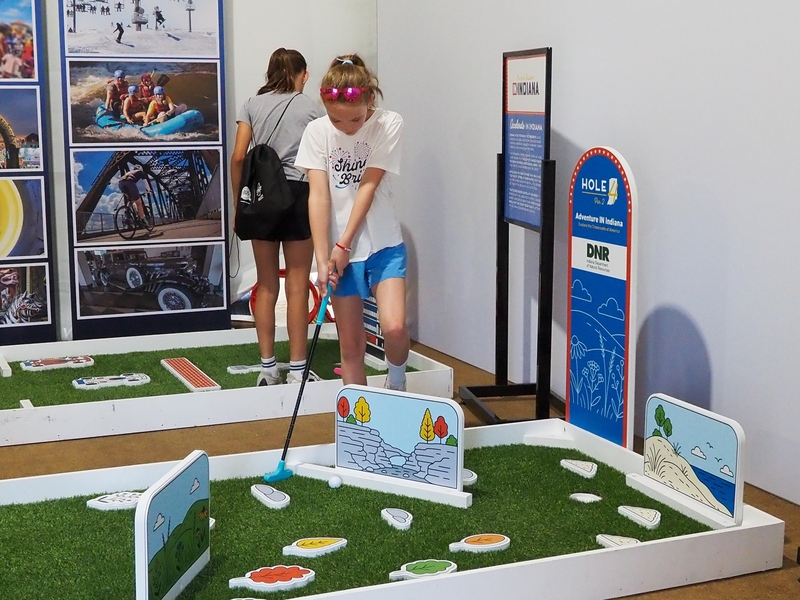 Emma Francus, 10, of Detroit, Michigan, plays mini golf at Indiana's golf-themed exhibit at the Freedom 250 Great American State Fair on the National Mall on Thursday, June 25, 2026. (Photo by Ashley Murray)