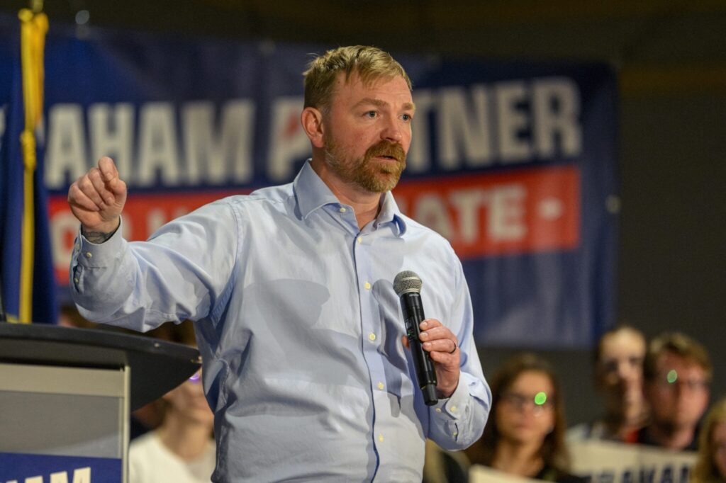 Maine's Graham Platner is the Democratic candidate for what's considered one of the nation's most competitive battles for the U.S. Senate. Platner, who is challenging incumbent Sen. Susan Collins, is shown at a rally at the Holiday Inn by the Bay in Portland on April 18, 2026. (Photo by Jim Neuger/ Maine Morning Star)