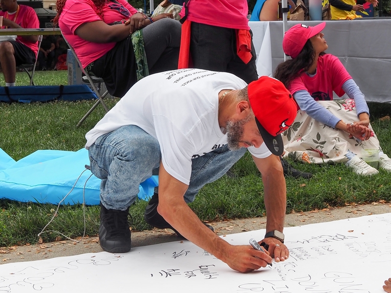 Pablo Andraes-Ranos, 44, of Hartford, Connecticut, who attended the Next250 march with Formerly Incarcerated, Convicted People & Families Movement, signed the rally's "Declaration of Interdependence" in Washington, D.C., on Saturday, June 27, 2026. (Photo by Ashley Murray/States Newsroom)