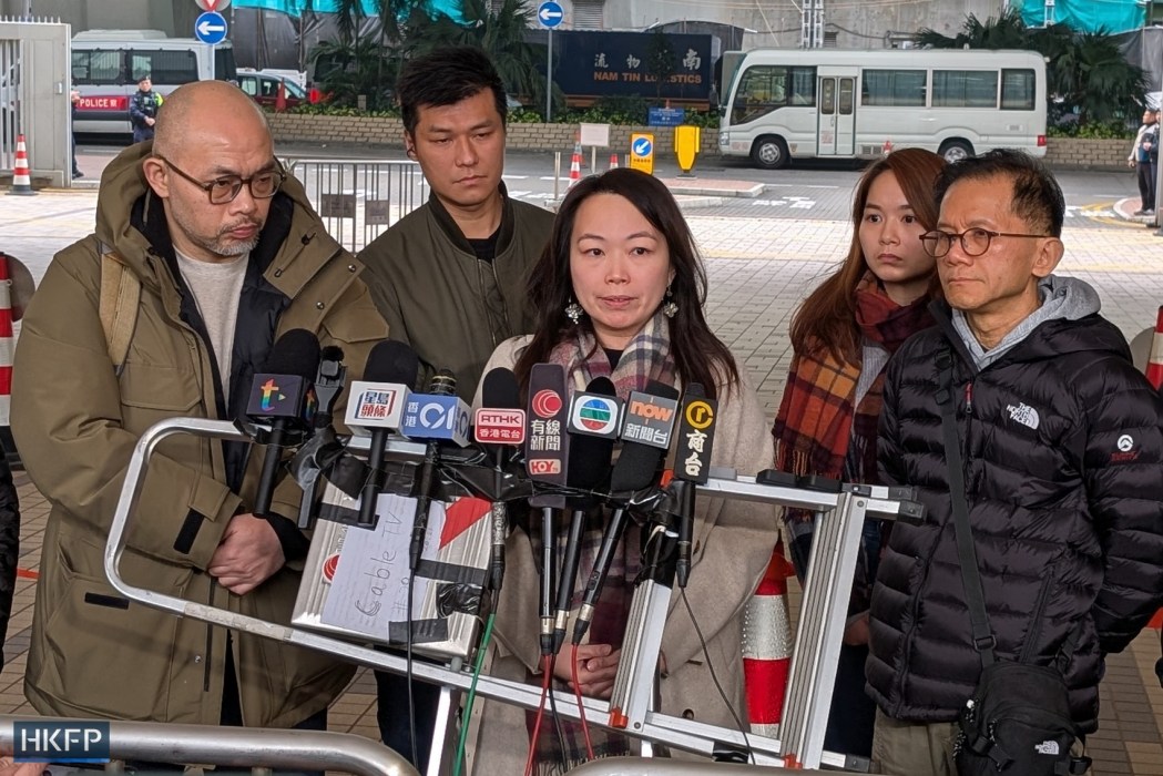 Ryan Tsui (first left), Alice Leung (centre), Philip Chiu (first right) and other bereaved family members of those killed in the 2012 Lamma ferry collision speak to the press at the West Kowloon Law Courts Building on January 22, 2026, expressing indignation over a long-awaited coroner's verdict. Photo: Hans Tse/HKFP.