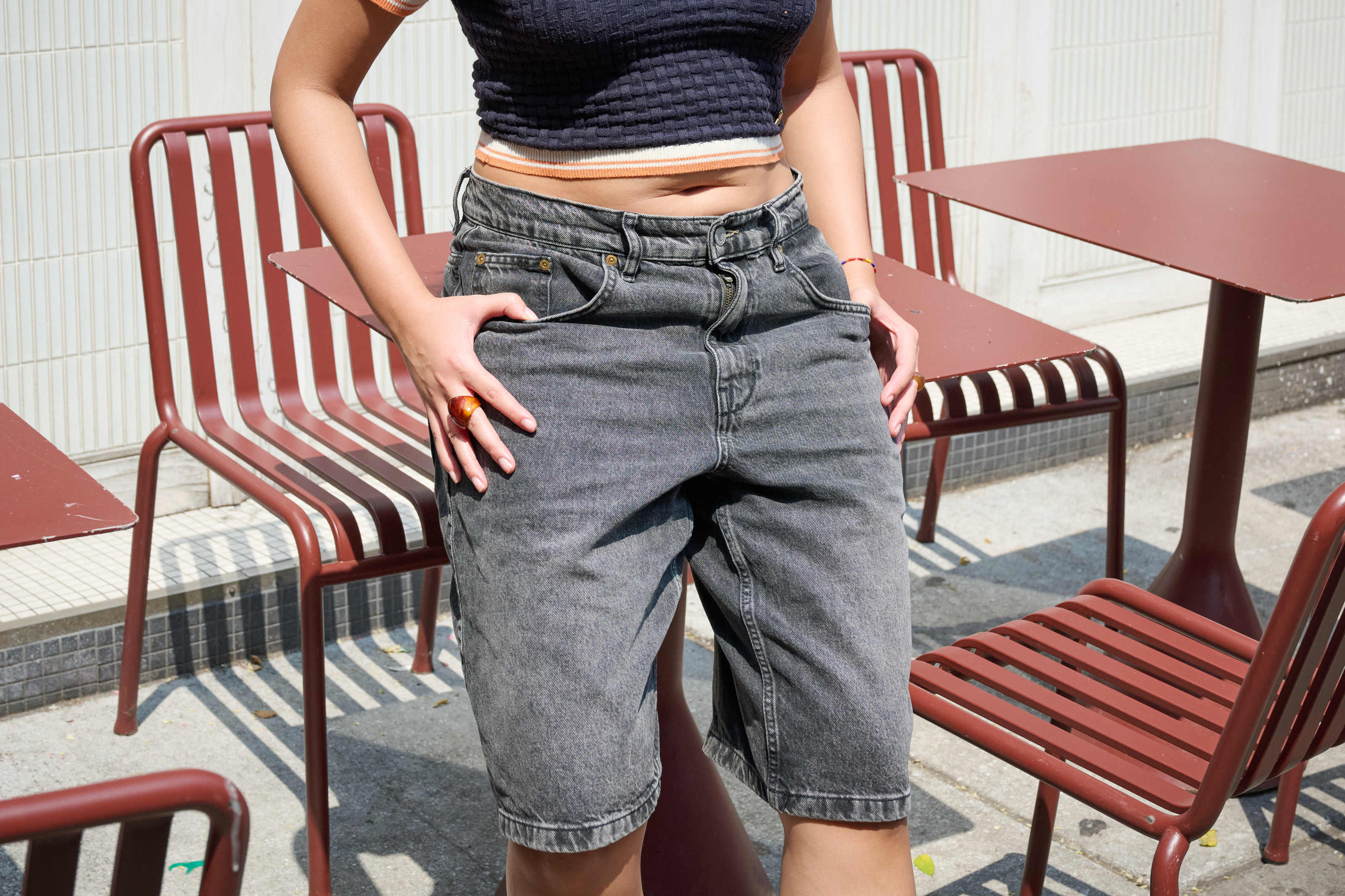 A woman wearing baggy jean shorts.