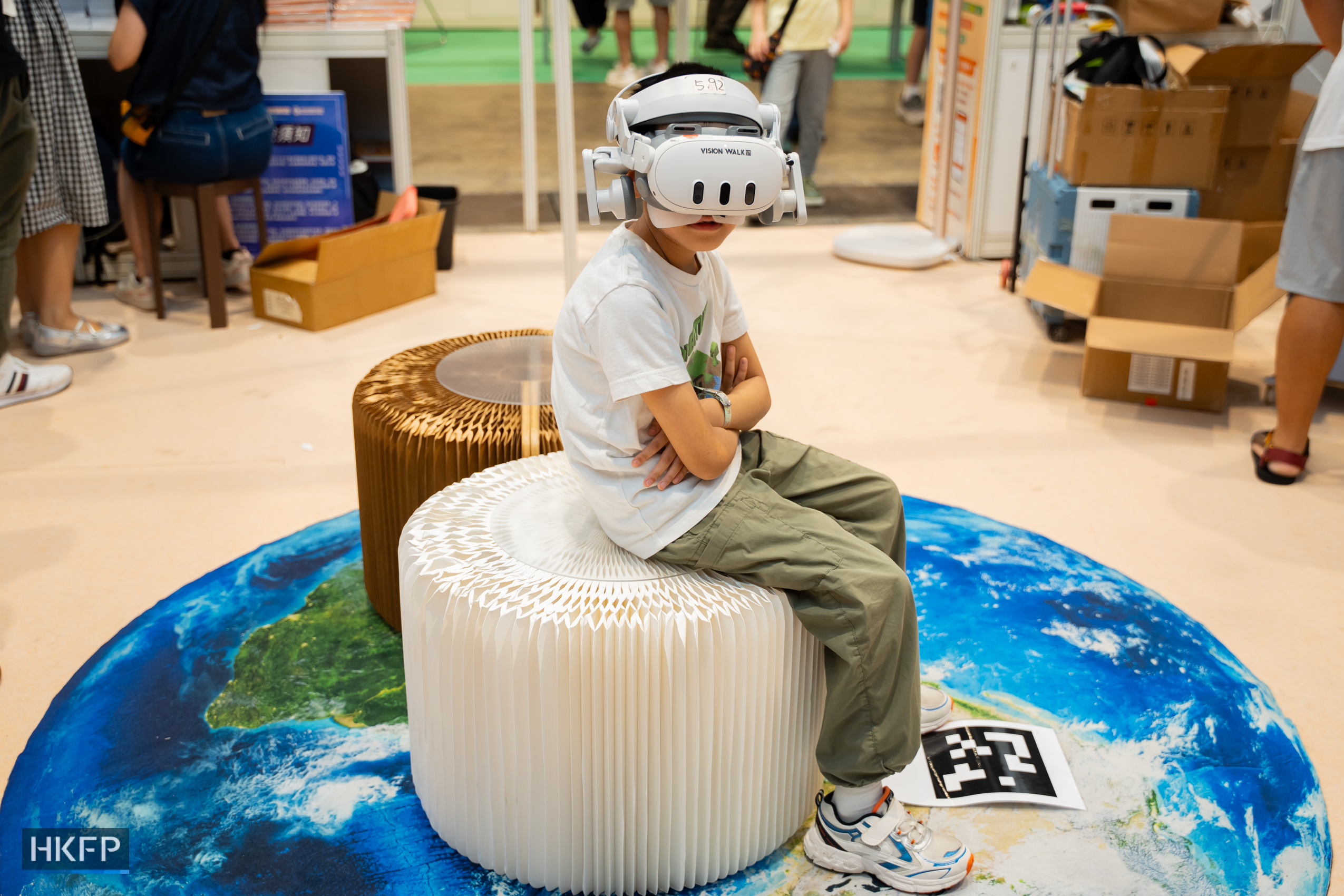A child wears a virtual reality headset at the Hong Kong Book Fair in Hong Kong Convention and Exhibition Centre in Wan Chai, on July 17th, 2026. Photo: Kyle Lam/HKFP.