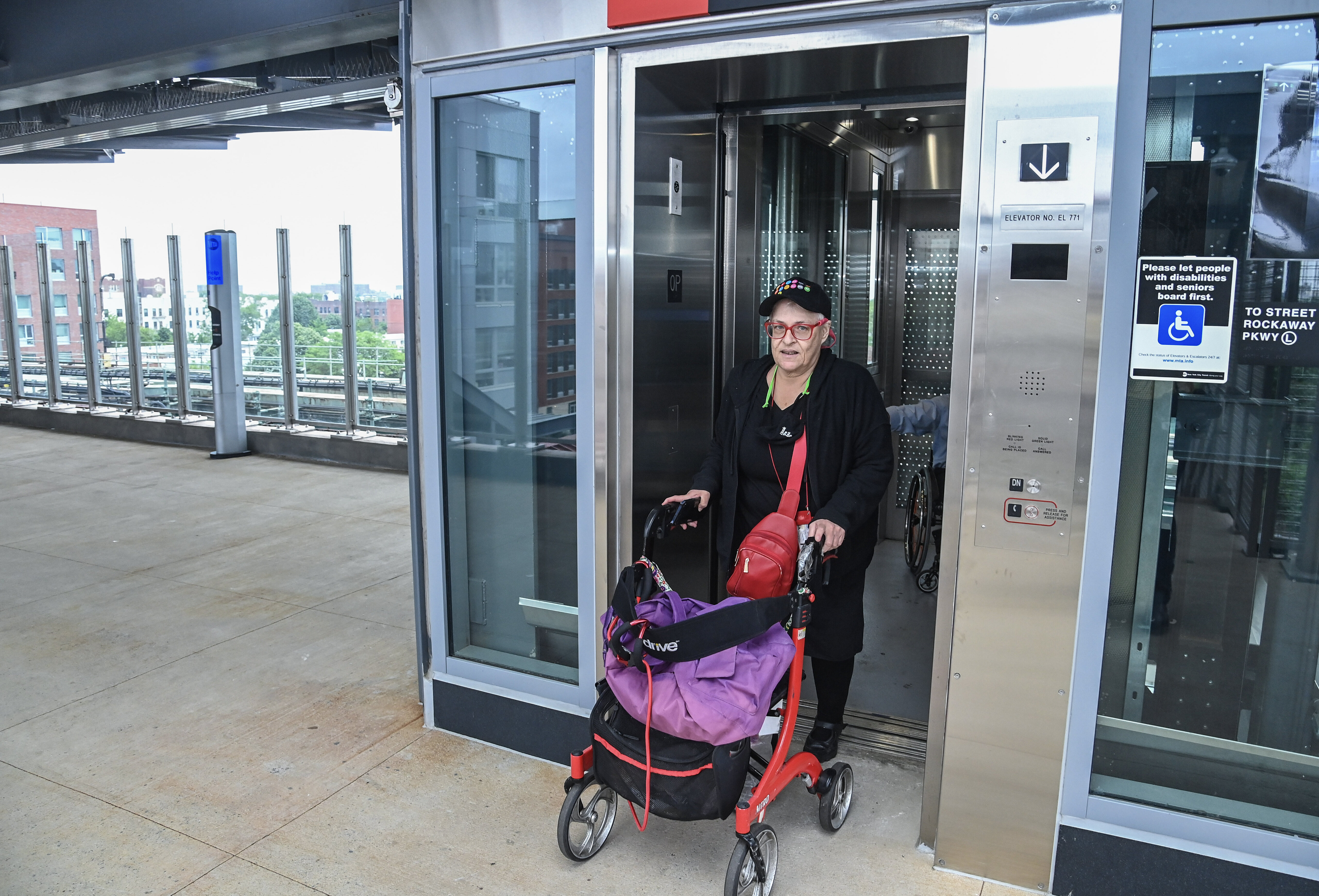 A woman at a subway elevator.