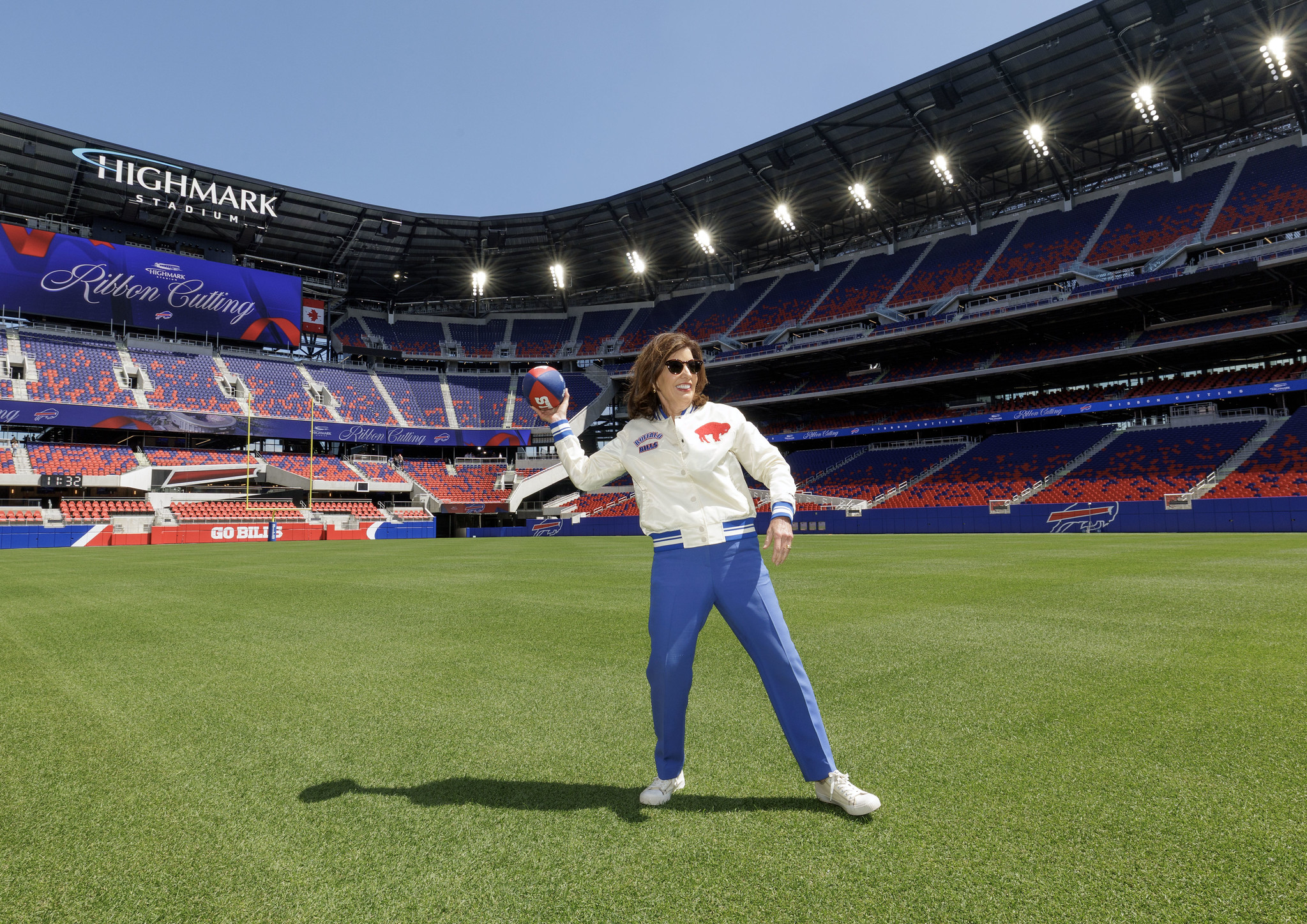 Kathy Hochul throws a football down the field at the new $2.1 billion Highmark Stadium in Buffalo.