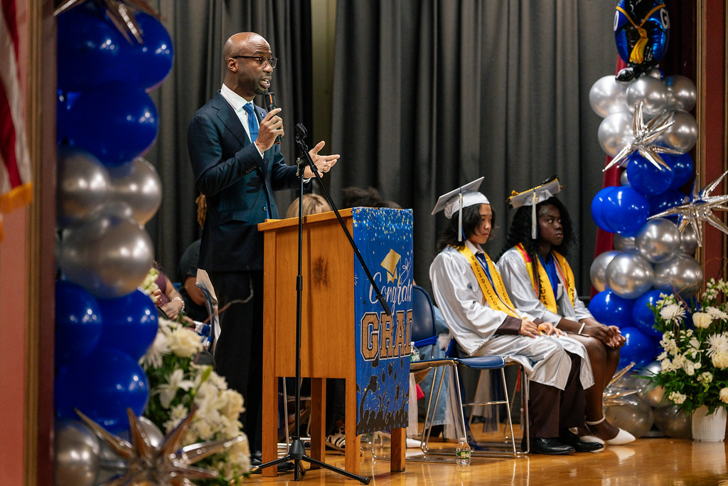 The school chancellor addresses students at graduation.