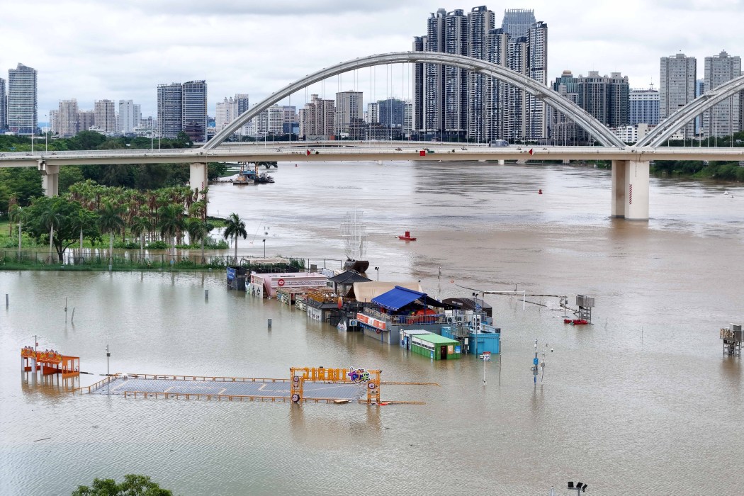 Flooded shops along a submerged riverside walk are seen by the overflowing Yongjiang river in Nanning, in China's southern Guangxi region on July 7, 2026. Photo by CN-STR/AFP/China OUT.