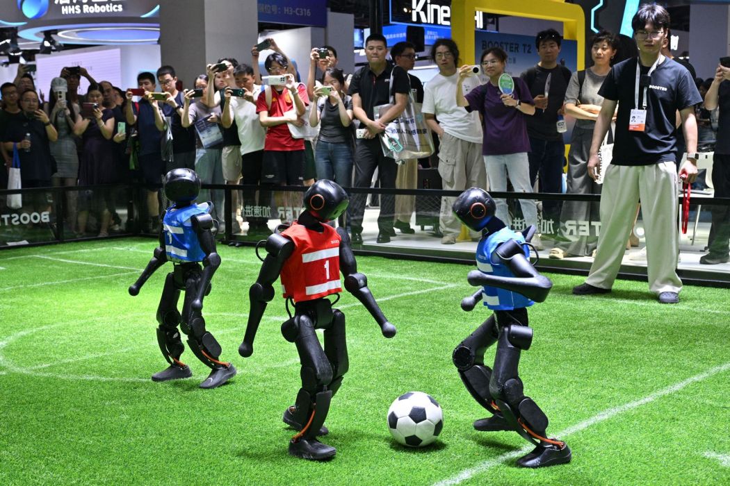 Humanoid robots from Booster Robotics play football.