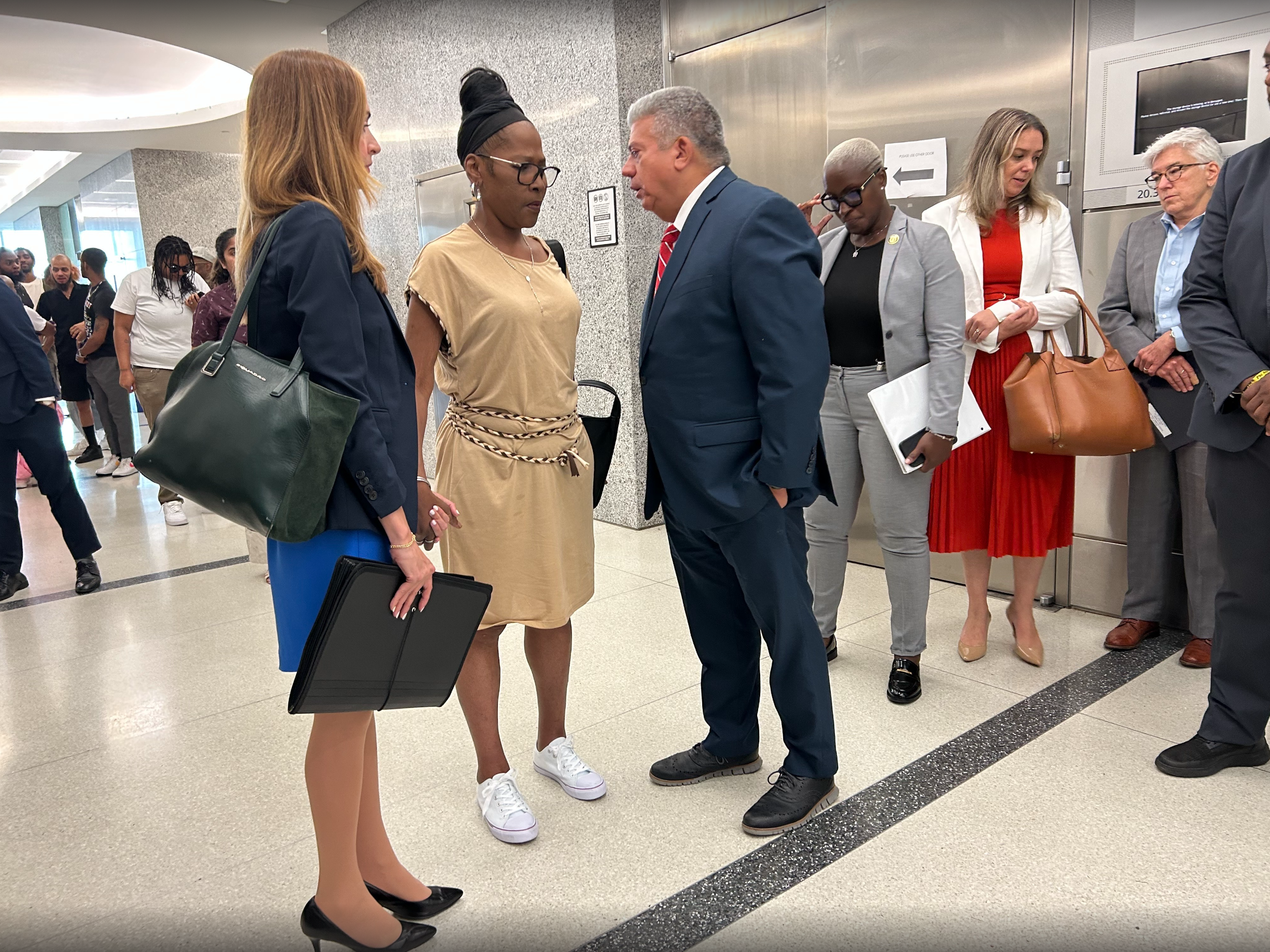 Senior Assistant District Attorney Sarah Jafari, left, holds the hand of Oneitha Sibley, O’Shae Sibley’s mother, with Brooklyn District Attorney Eric Gonzalez after the sentencing.