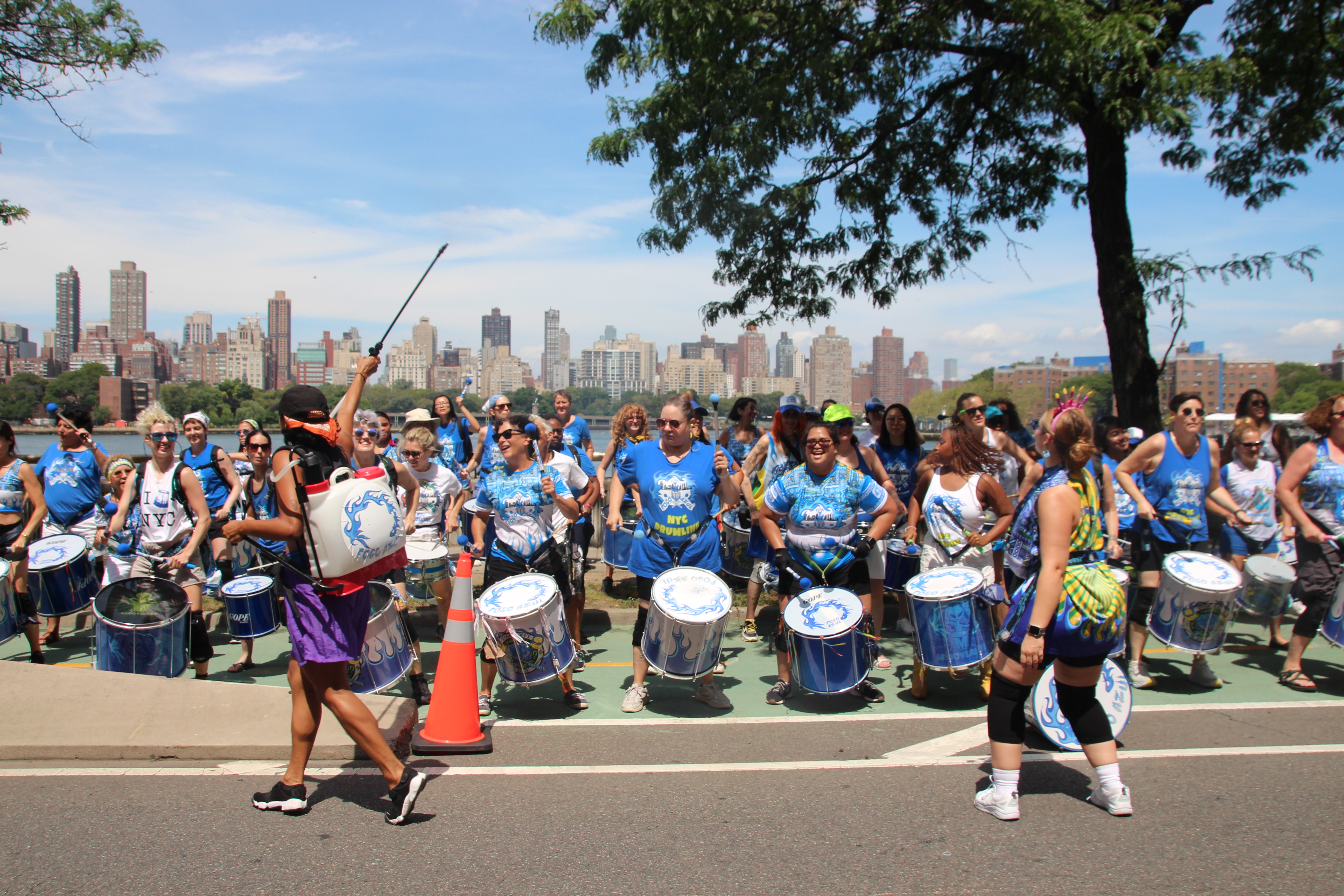 A music group plays on a temporarily car-free street Queens in 2023, the first year Summer Streets expanded to all five boroughs.