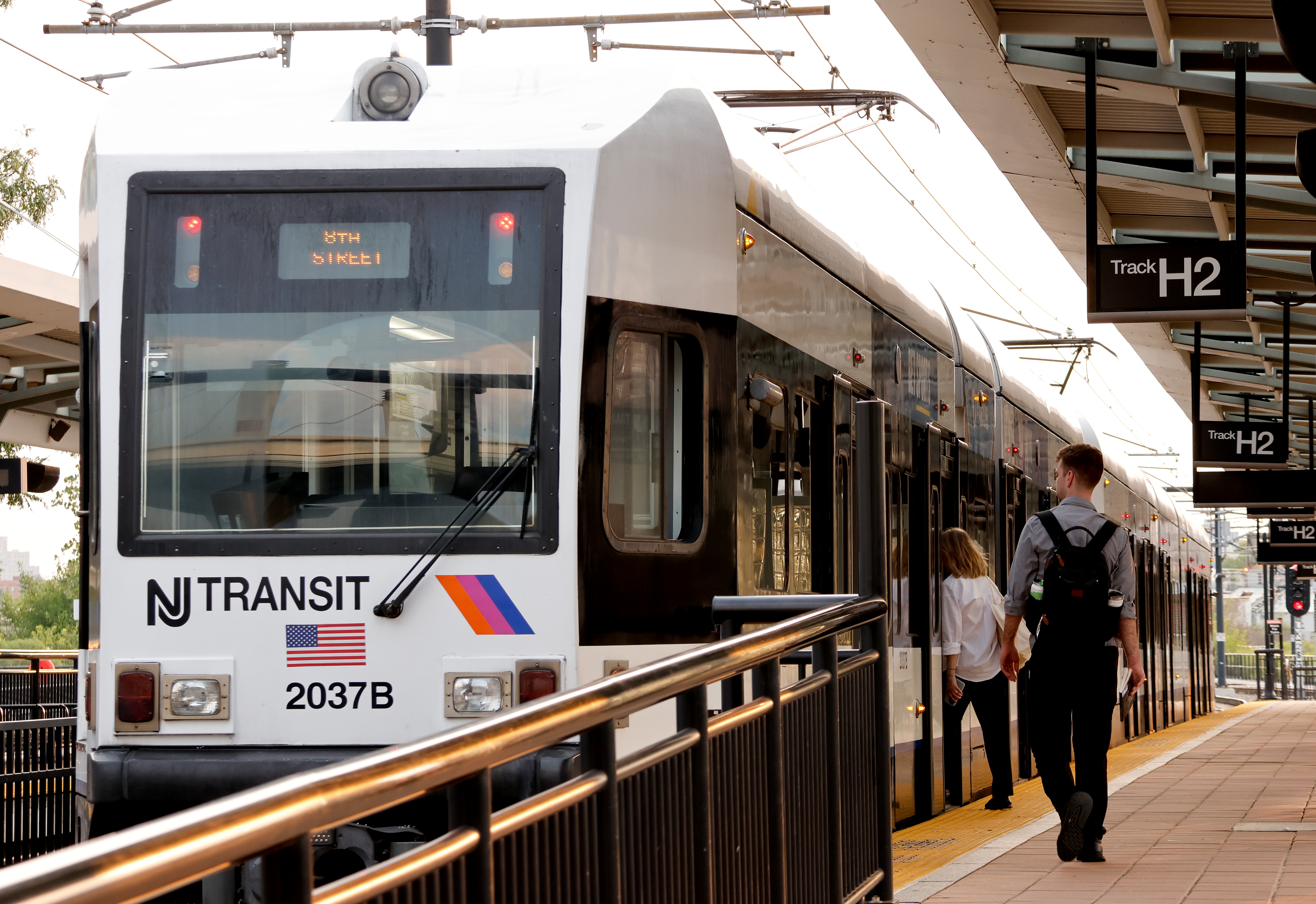 People board a NJ Transit light rail train in Hoboken in 2024.
