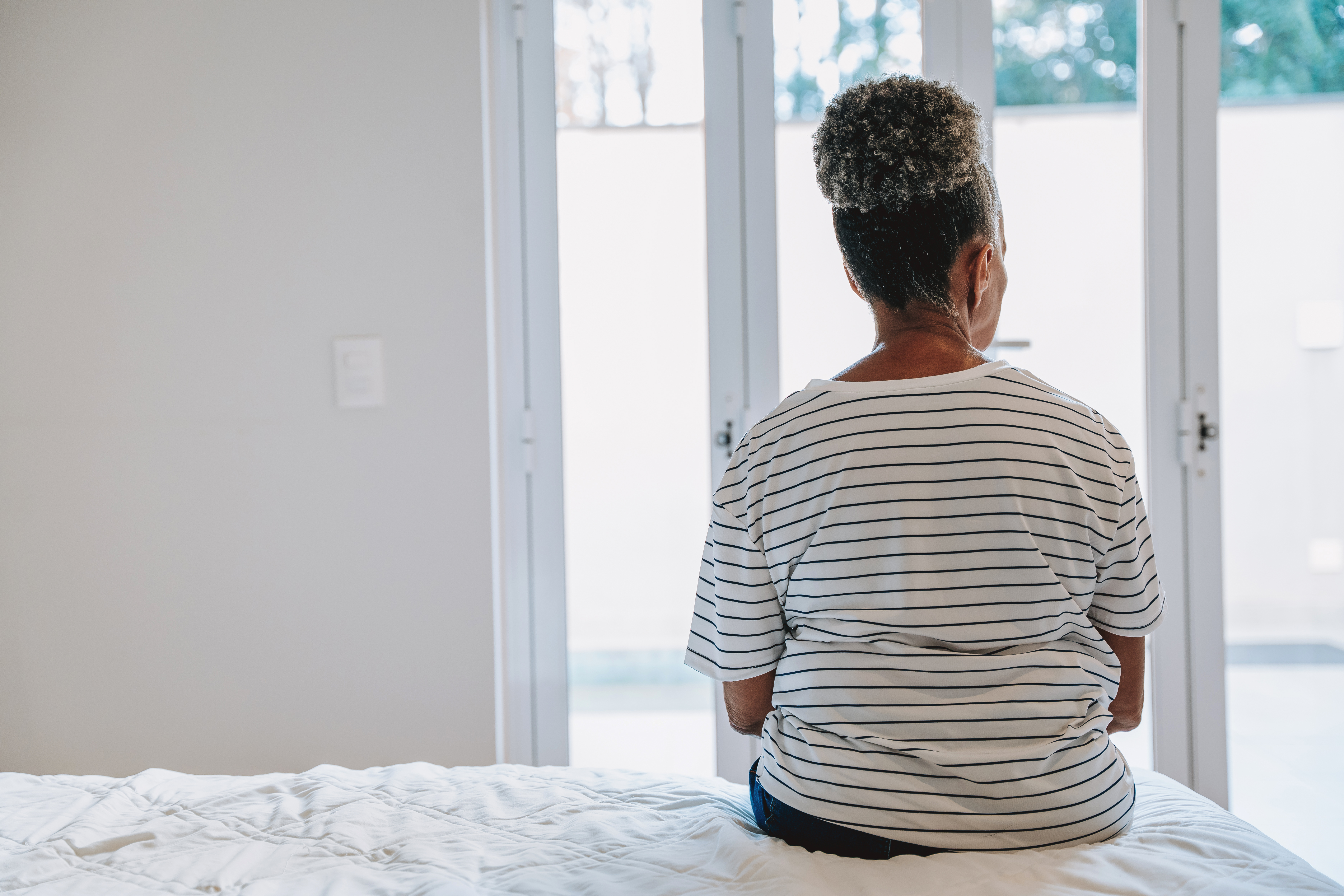 A woman sitting on a bed