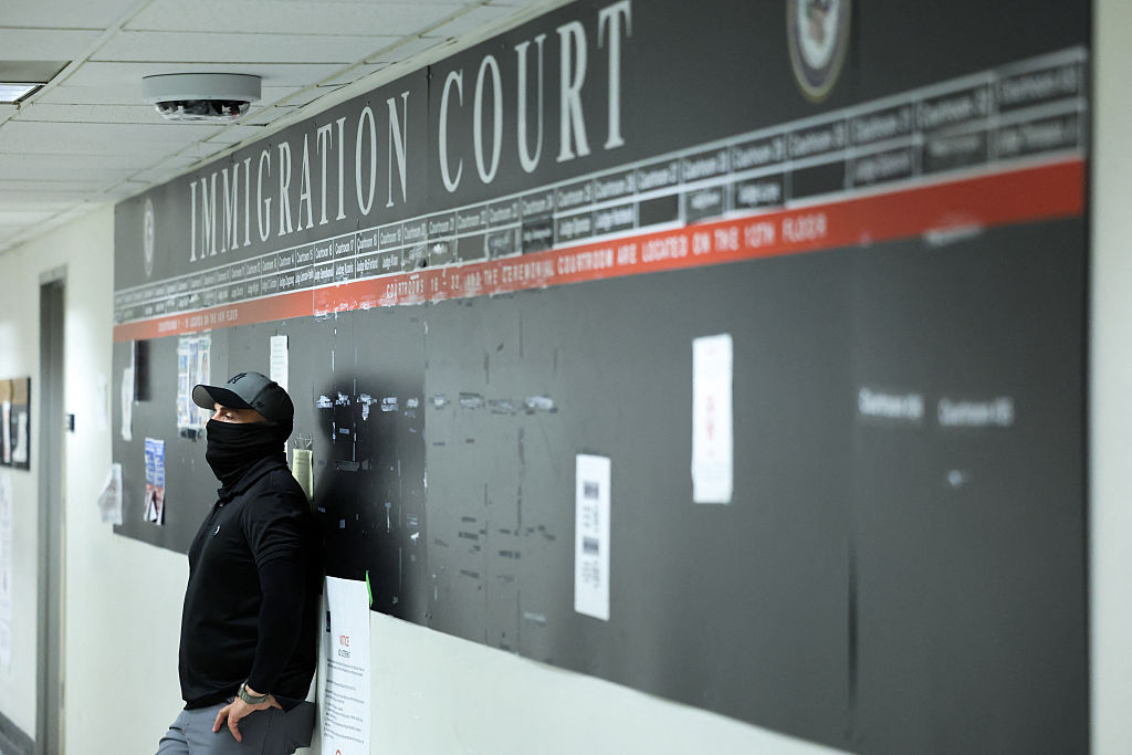 A federal officer stands by in a hallway at New York Federal Plaza Immigration Court inside the Jacob K. Javitz Federal Building in Manhattan on Oct. 1, 2025.