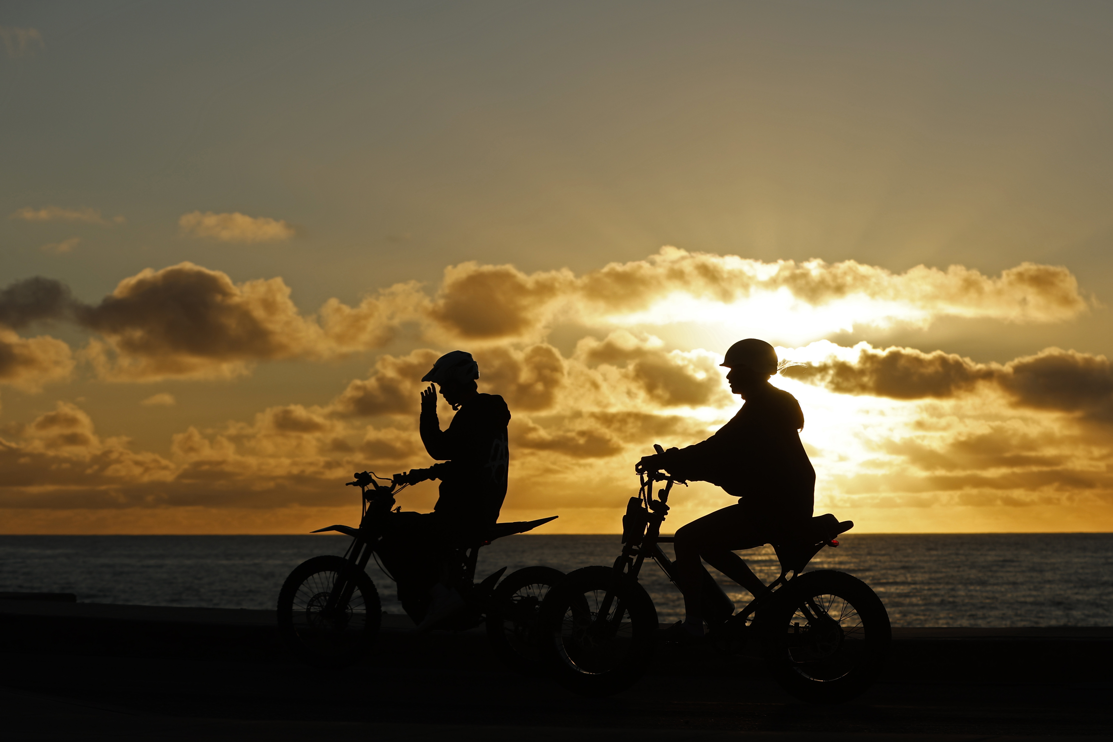 Teenagers ride electric motorcycles