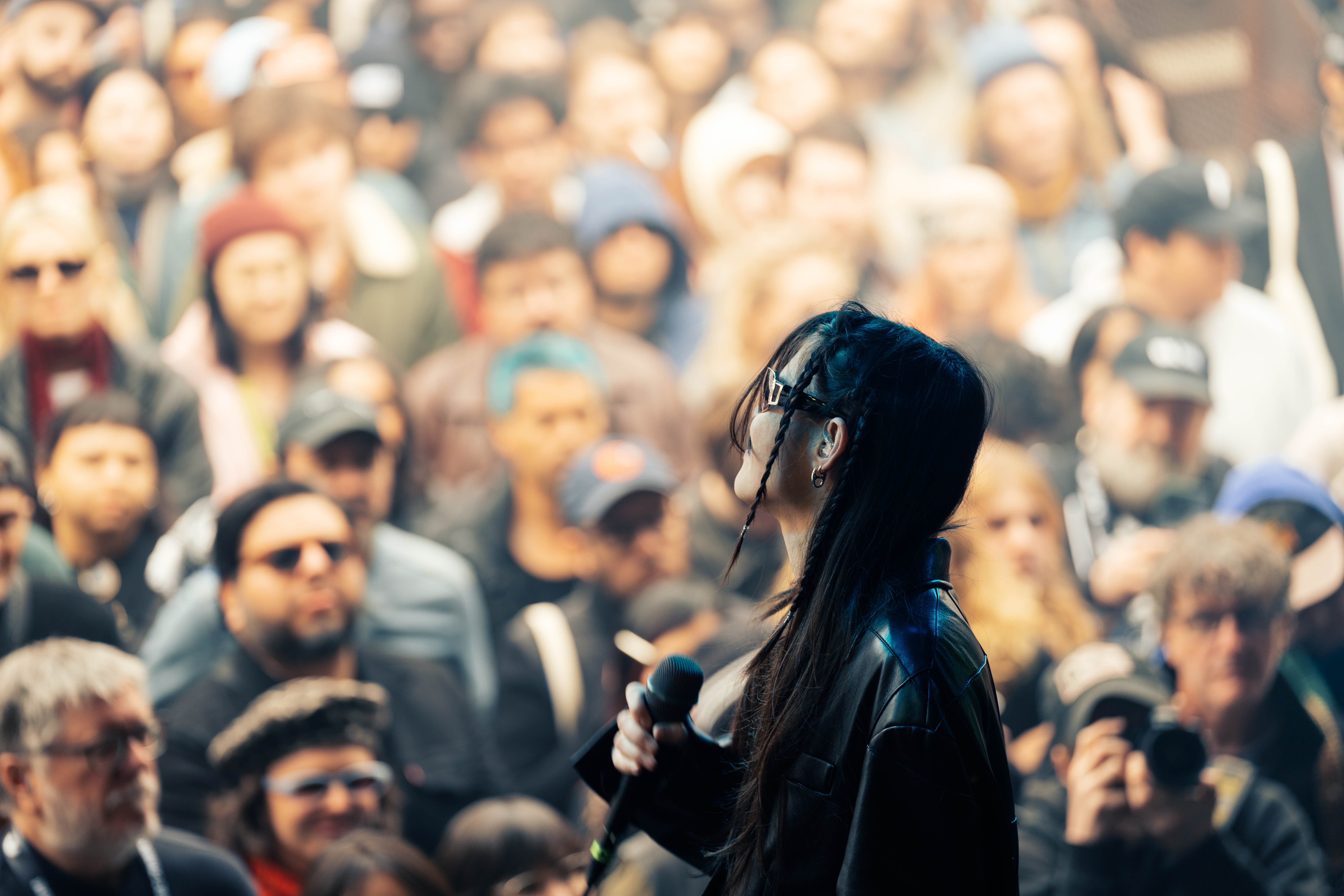 The singer from the band Water From Your Eyes stares out at a large crowd.