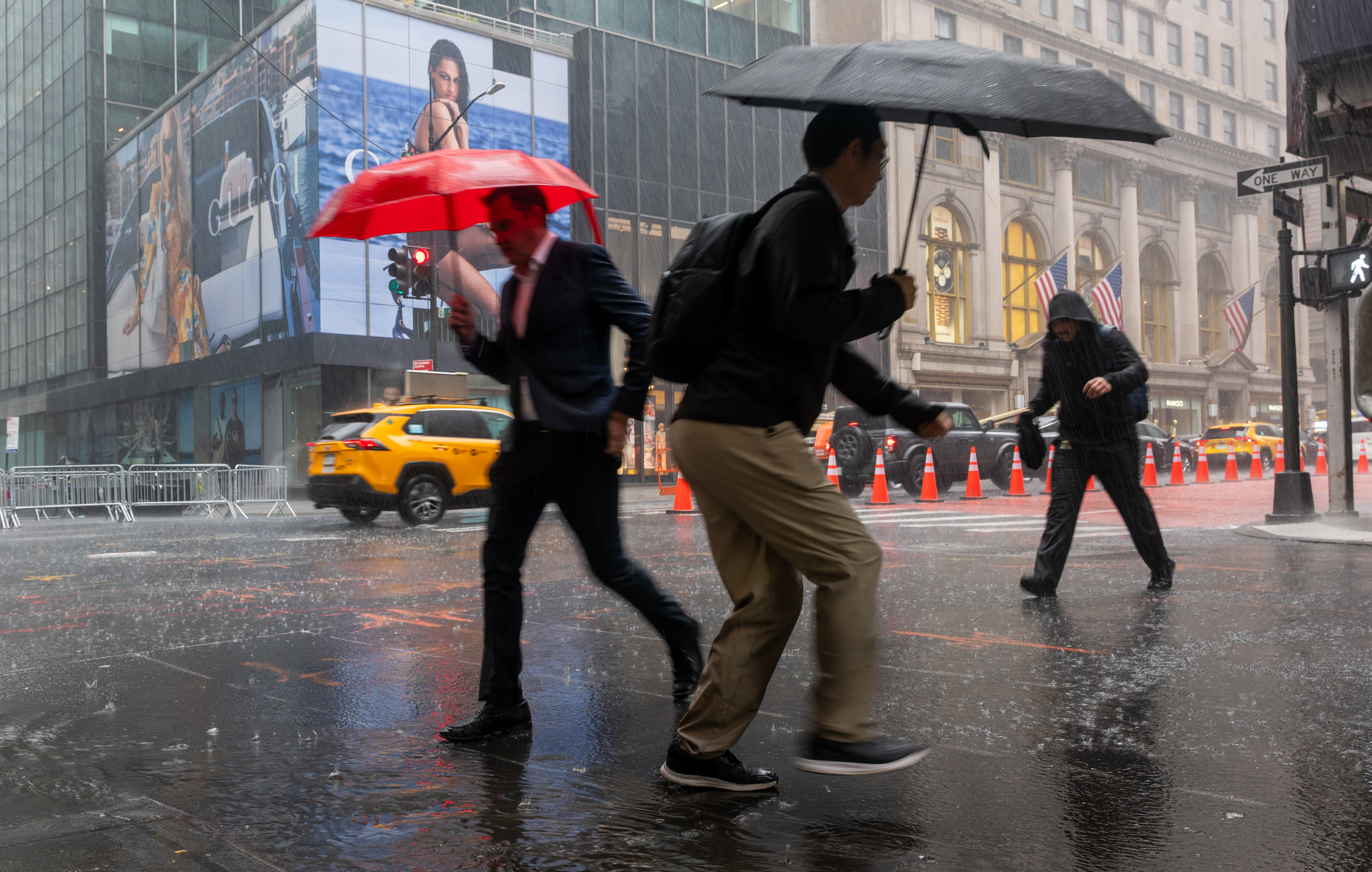People walk through the rain along 5th Avenue in Manhattan during a late-June storm.