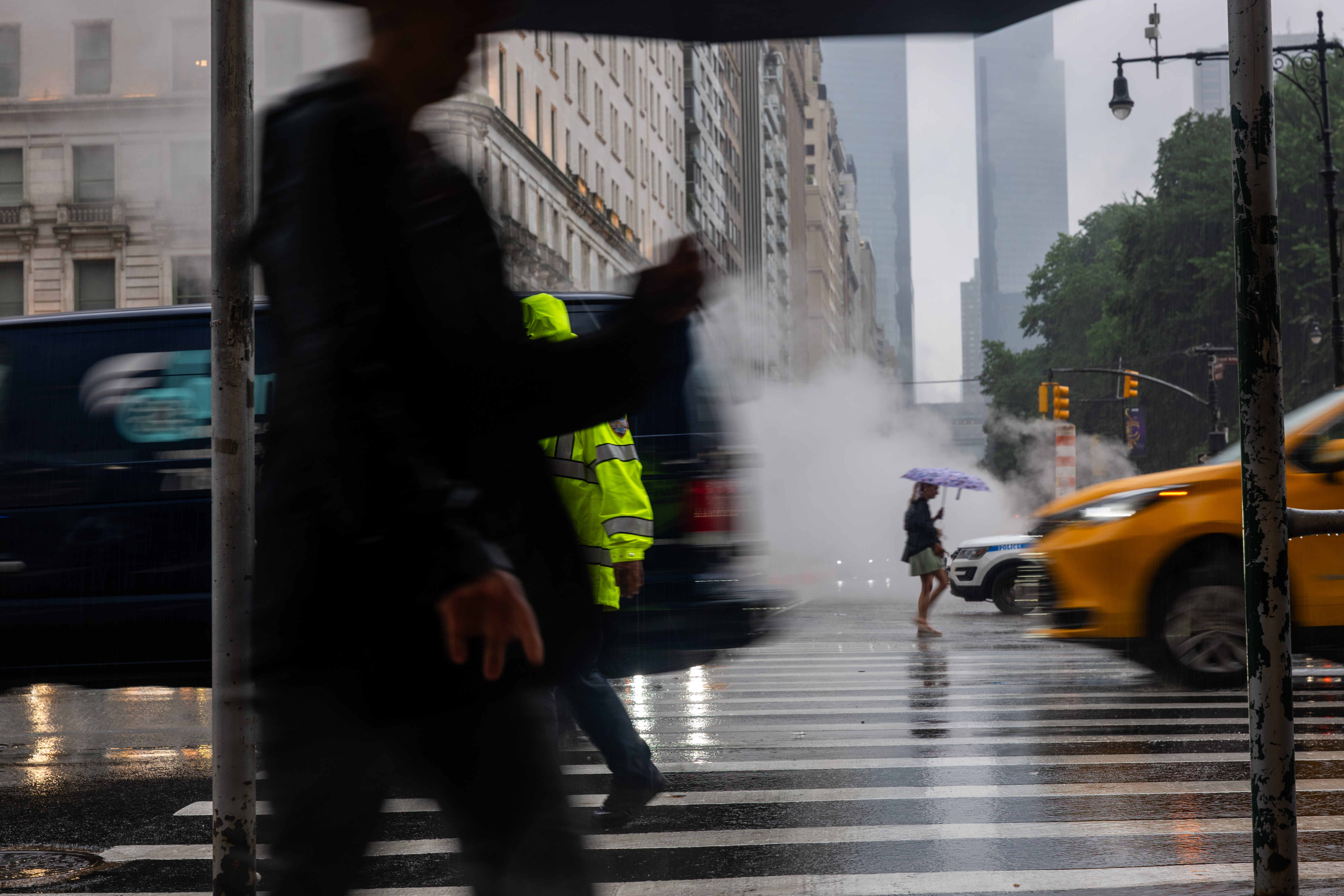 People walk through the rain along 5th Avenue in Manhattan.
