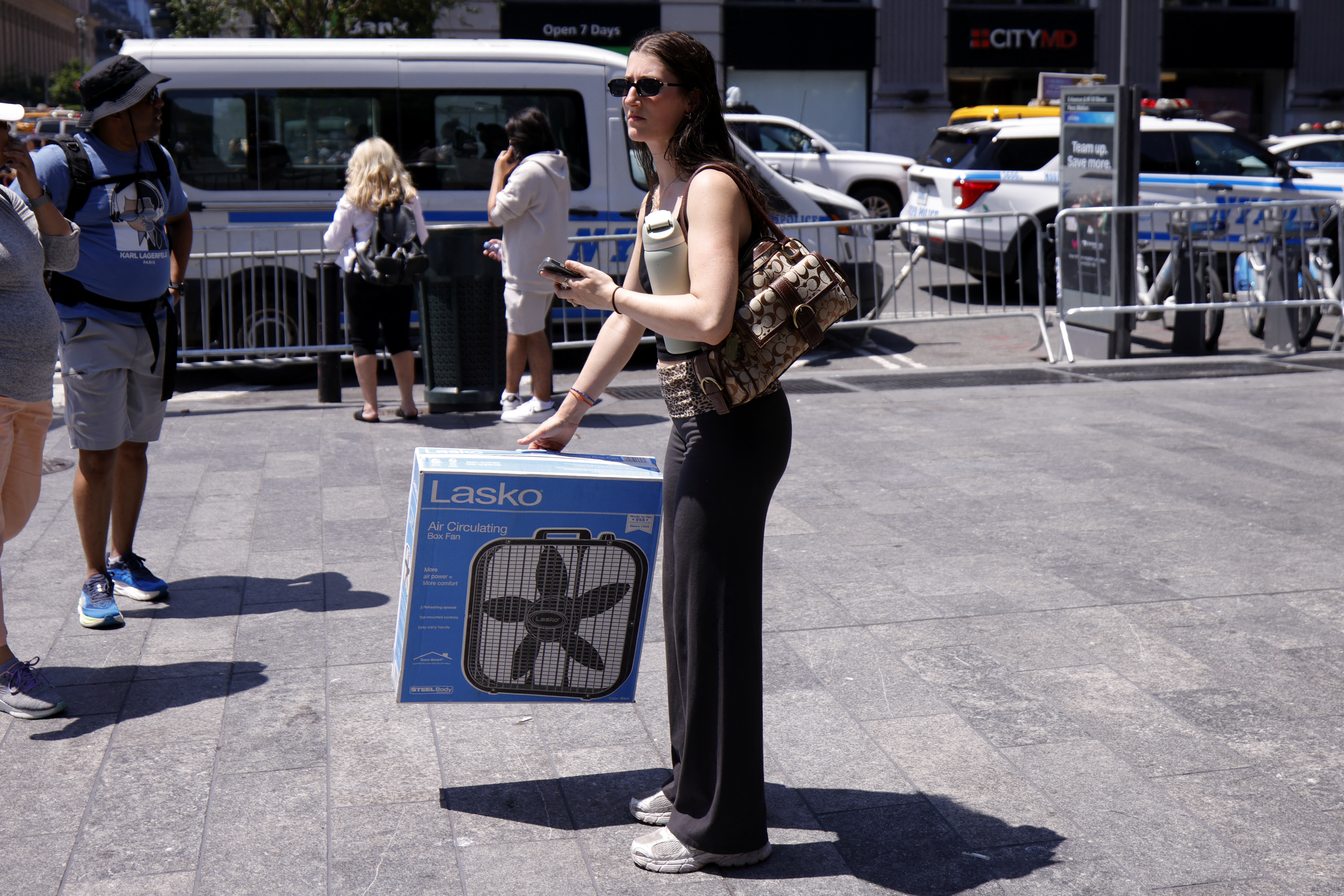 A woman carries a box fan in midtown Manhattan during a heatwave in New York on July 3.