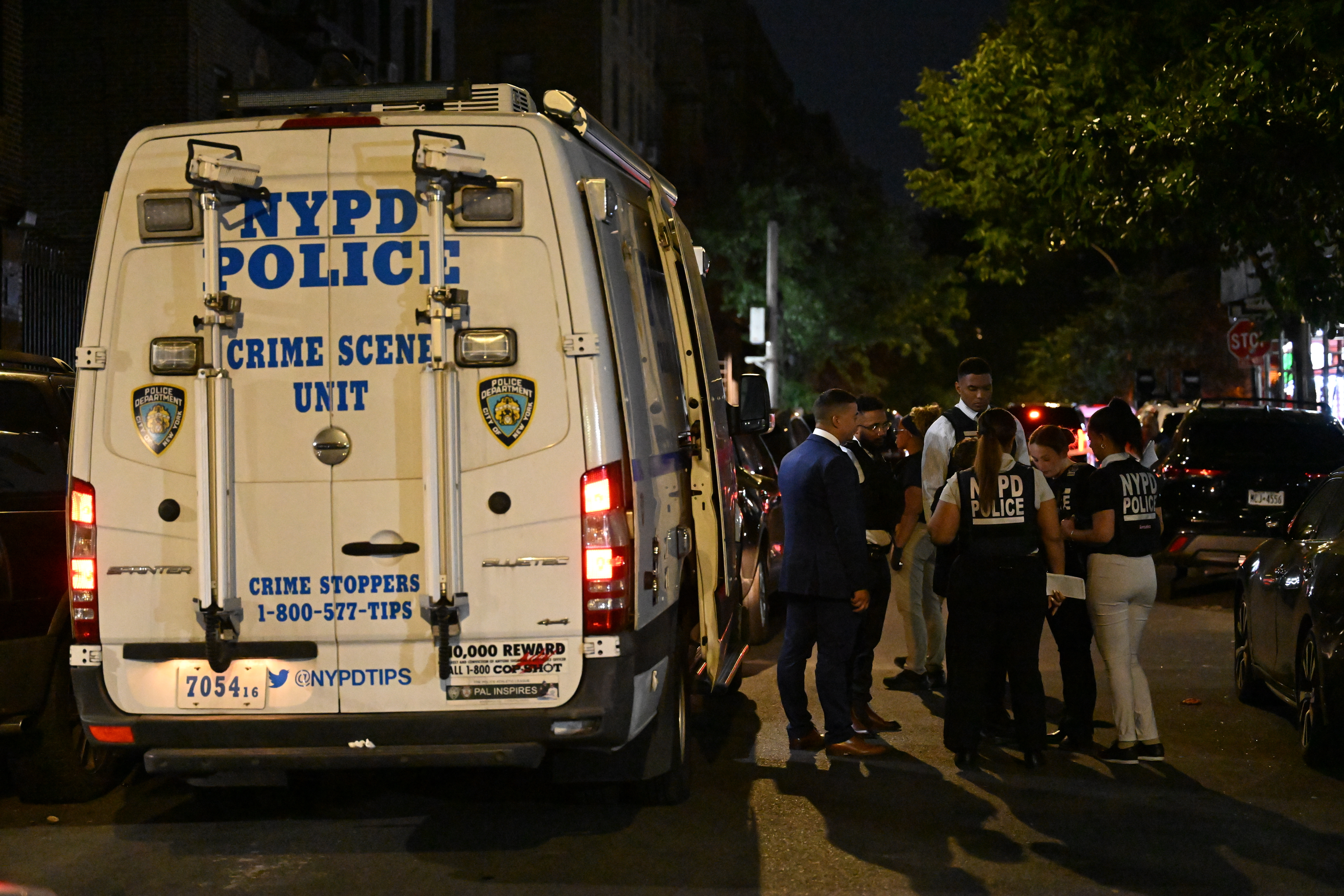 NYPD officers work the scene where a 12-year-old boy was killed and two men were injured in a shooting outside of a Supermarket and Deli at 104 Elliot Place in Bronx, New York, United States on July 25, 2026.