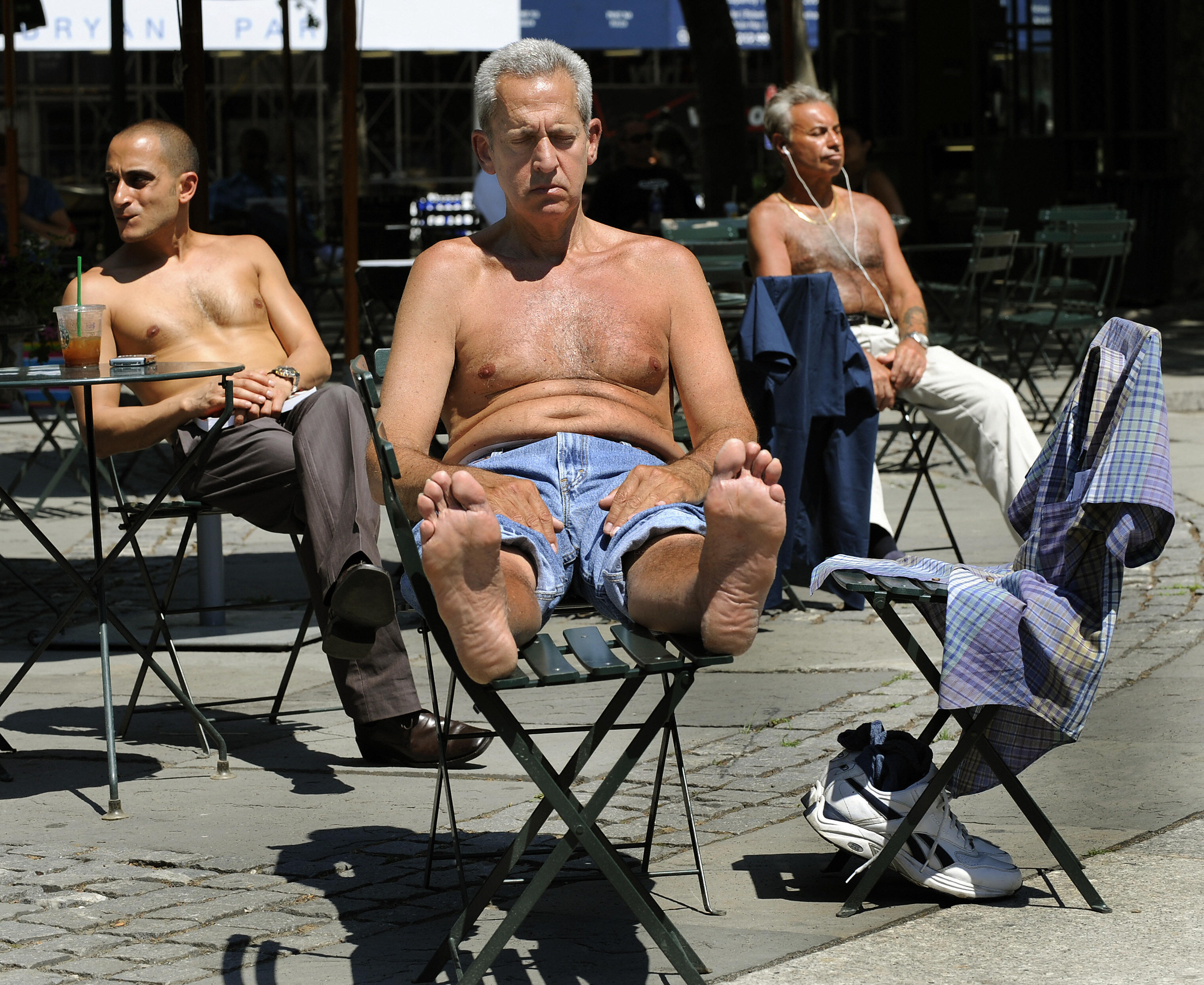 New Yorkers go shirtless as they try and beat the heat at Bryant Park in 2008.